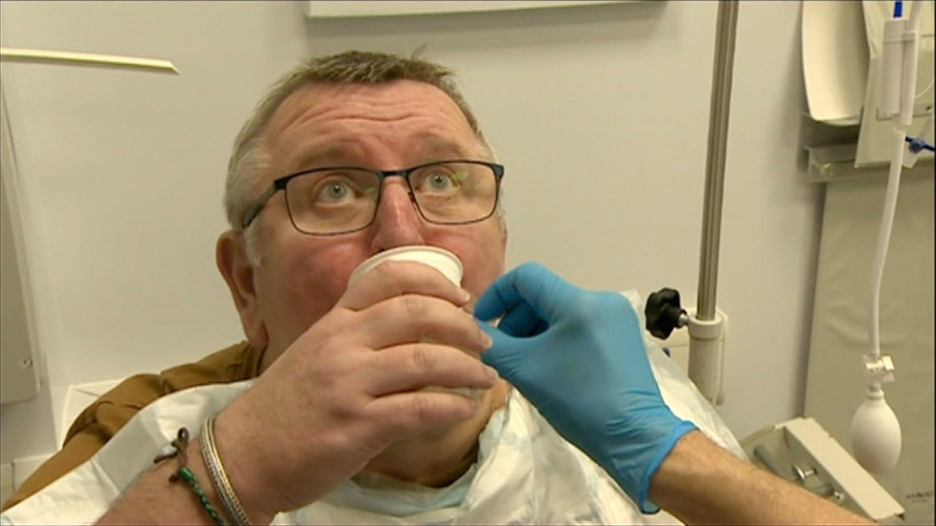 A man swallows a pill containing a balloon in hospital.