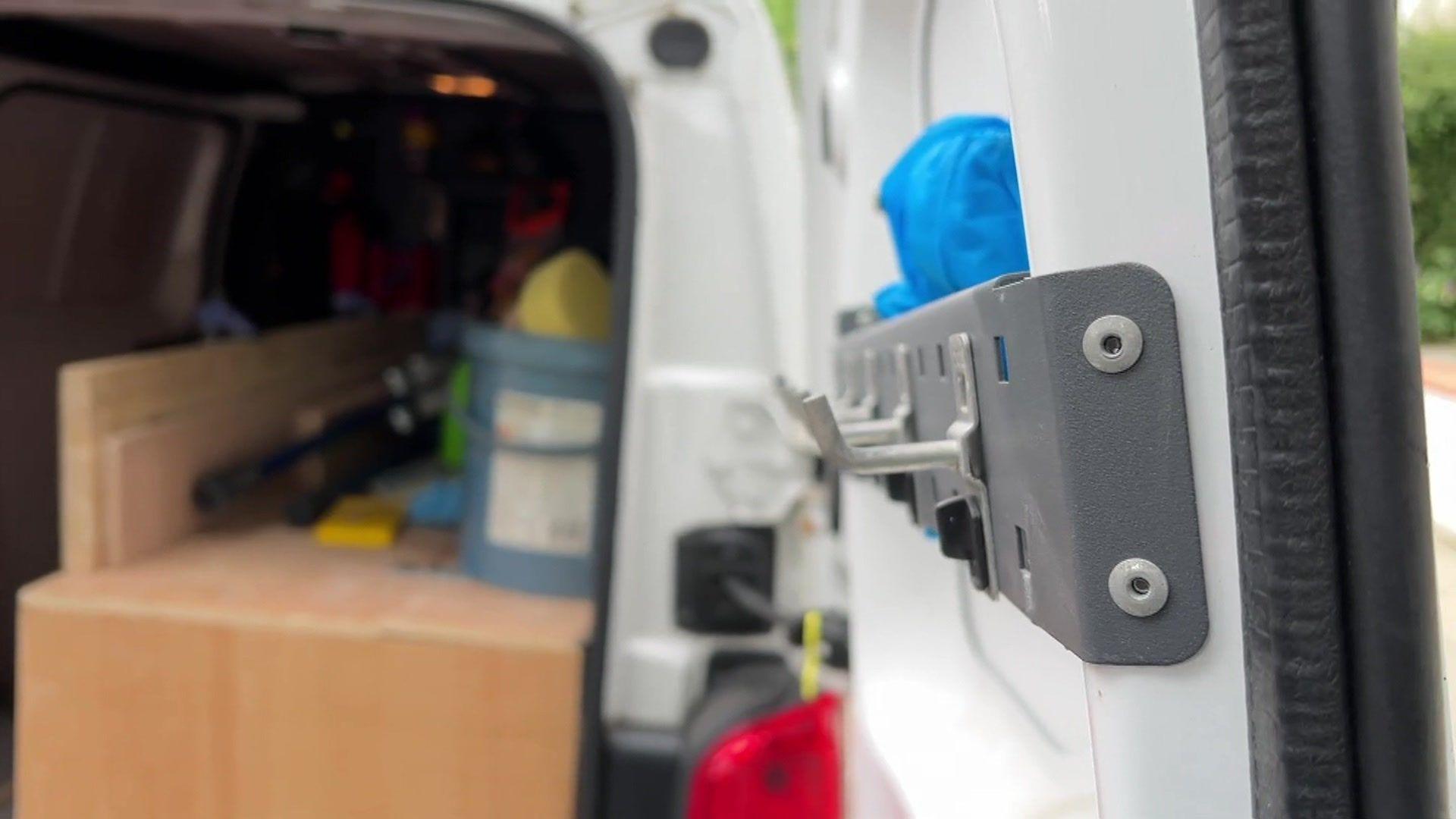 Interior view of Roy's work van with hooks, tools and wood inside