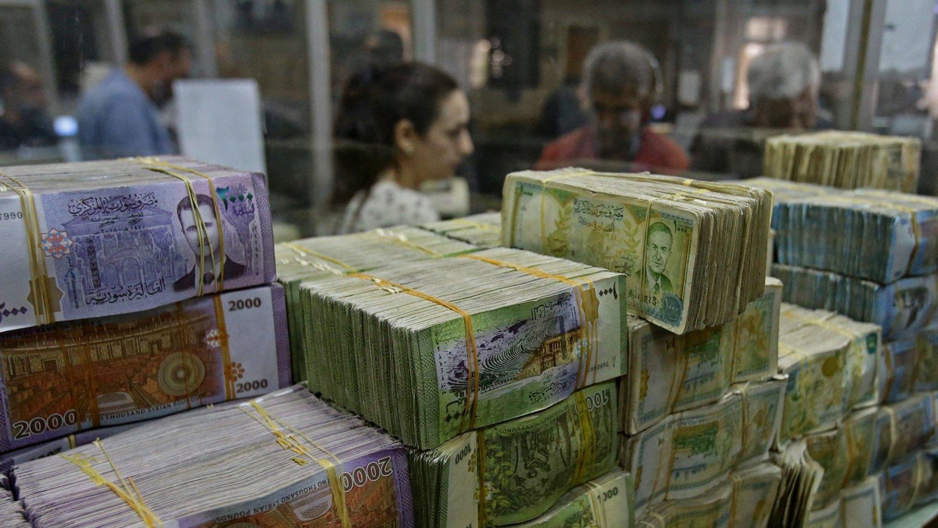 File photo showing stacks of Syrian pound notes at the Commercial Bank of Syria in Damascus, on 10 November 2022