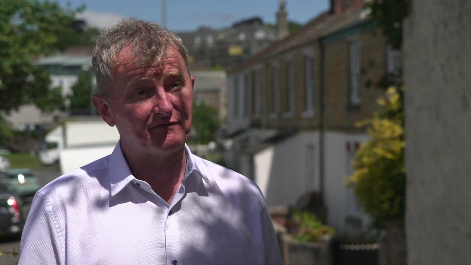 Steve Rubidge in front of buildings