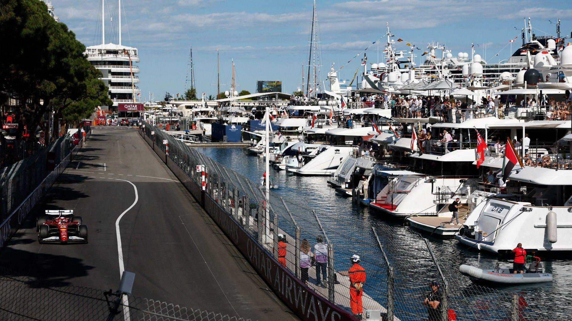 Charles Leclerc drives past the yachts in the Monaco harbour 