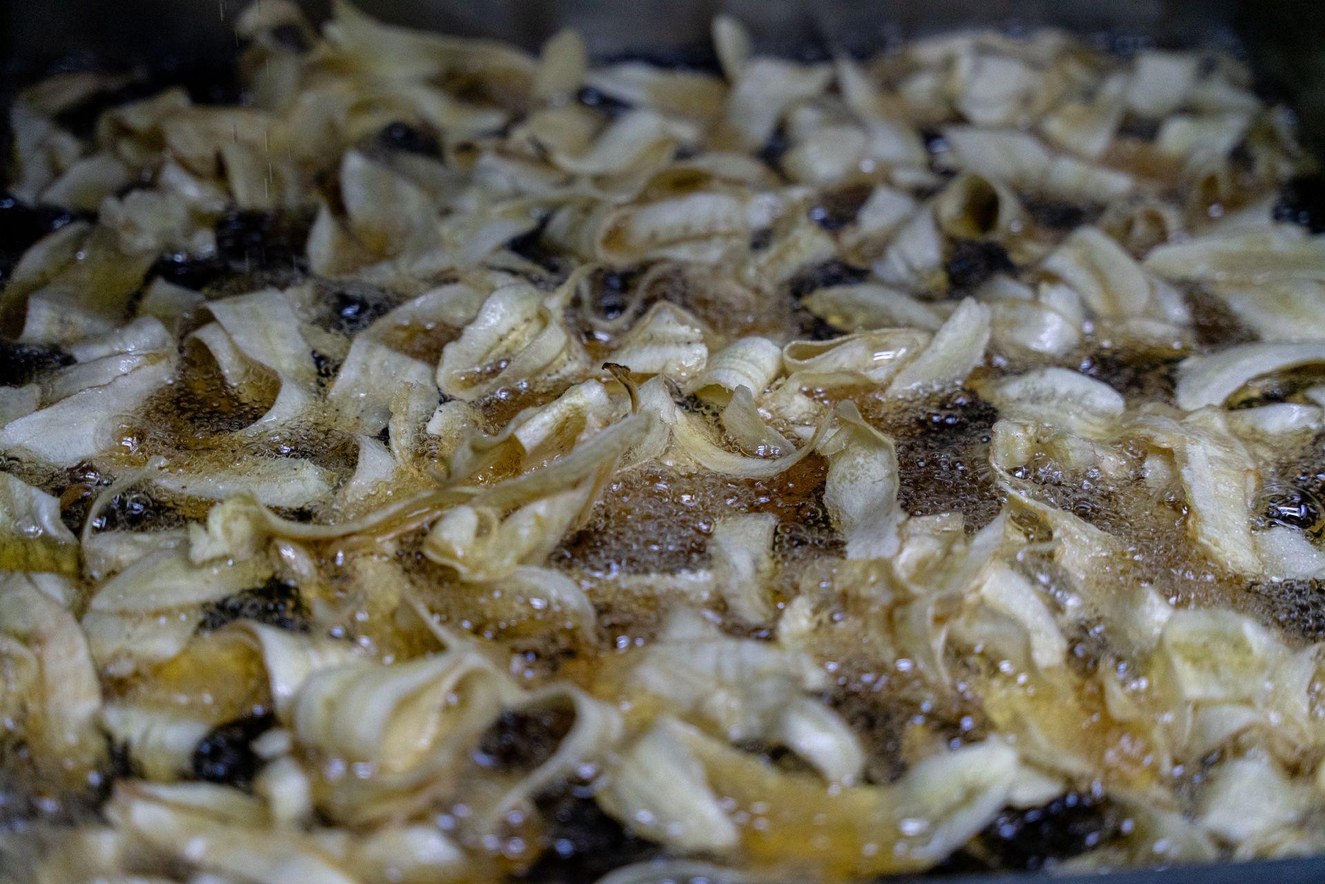 Plaintain strips are frying in cooking oil at Los Pollos Locos in Comayagua, Honduras