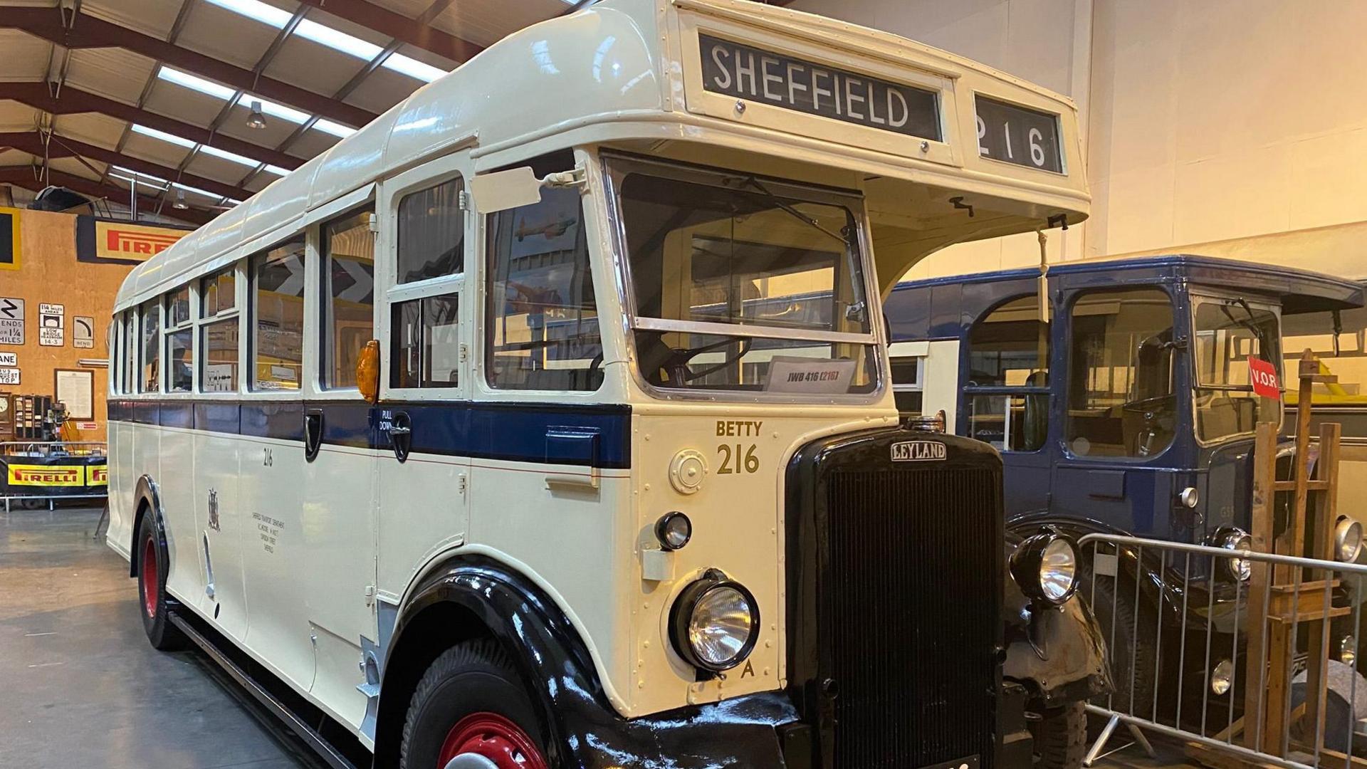 A restored 1940s single-decked bus in cream paintwork, bearing the name 'Betty' on its front