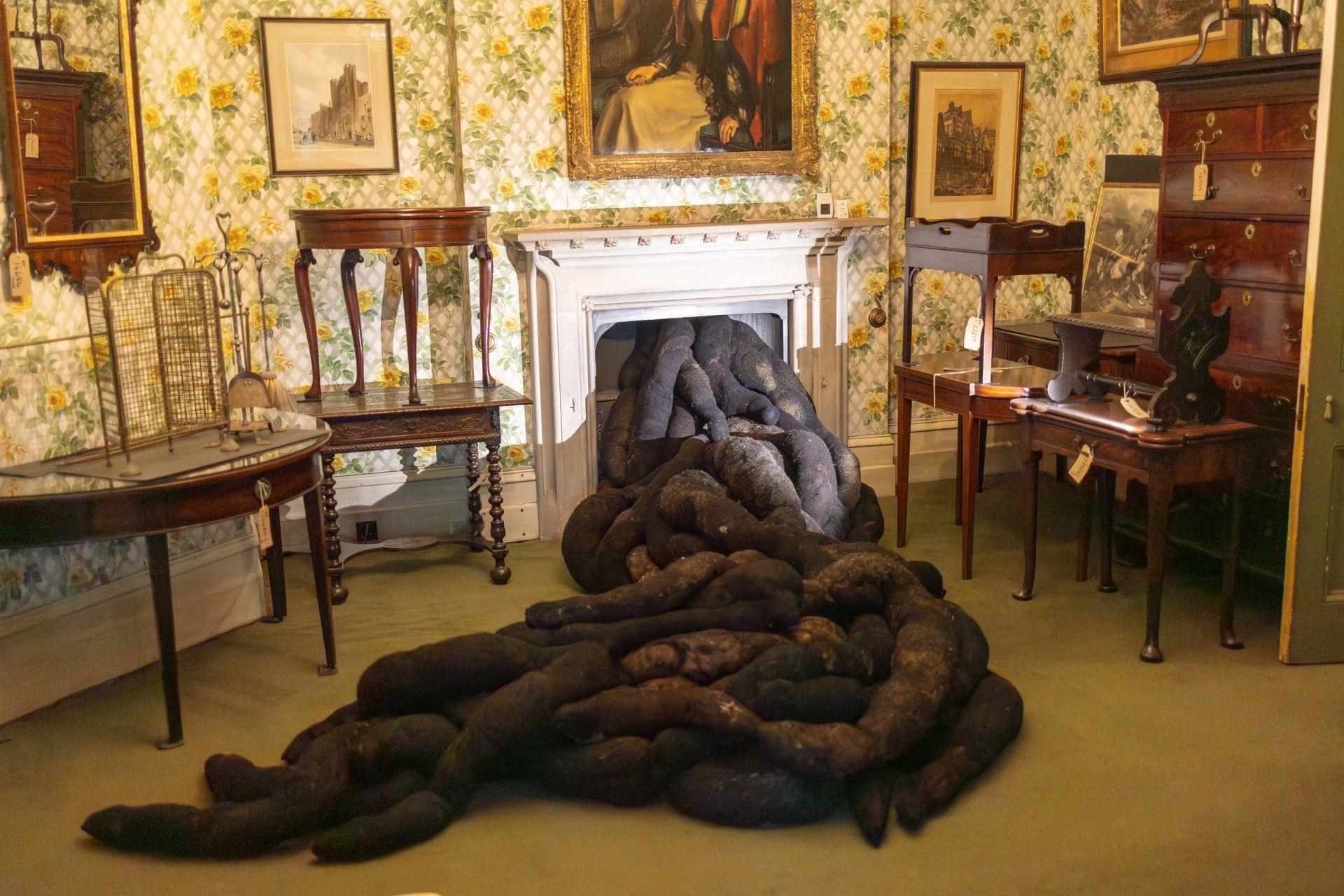 An installation made of wool and horsehair, which looks like intestines, is seen spilling out of a fire place at Tyntesfield House in North Somerset