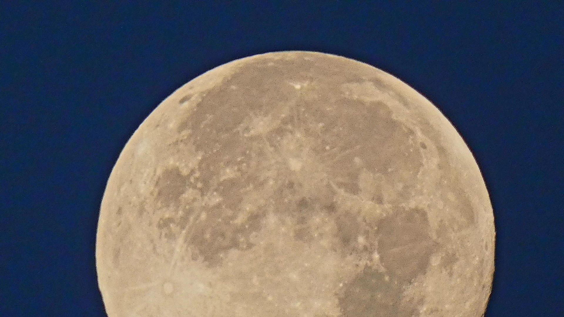 Large image of the Moon against a dark blue sky