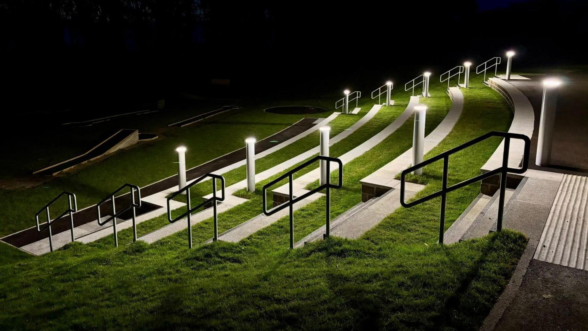 Concrete terraced seating lit up at night