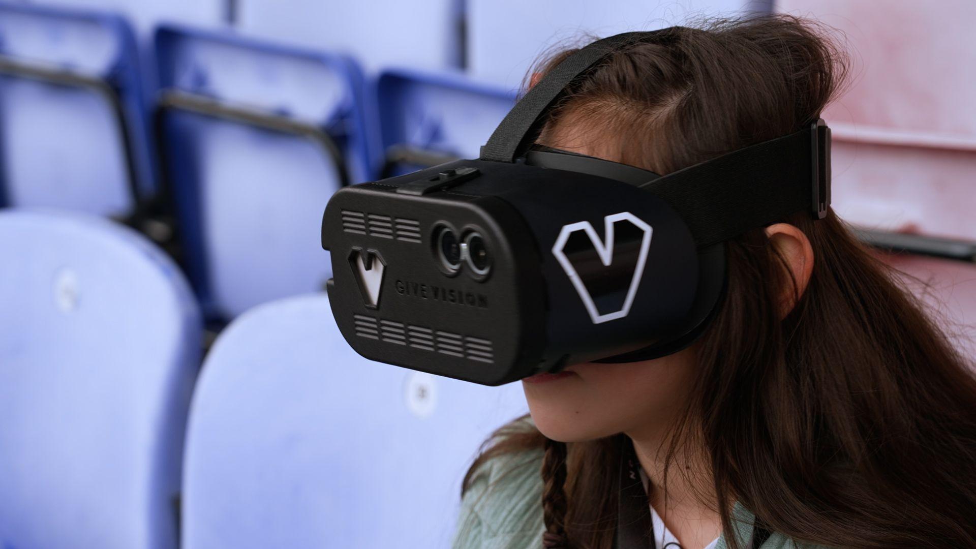 Young football fan Sophia wearing a black headset with a camera