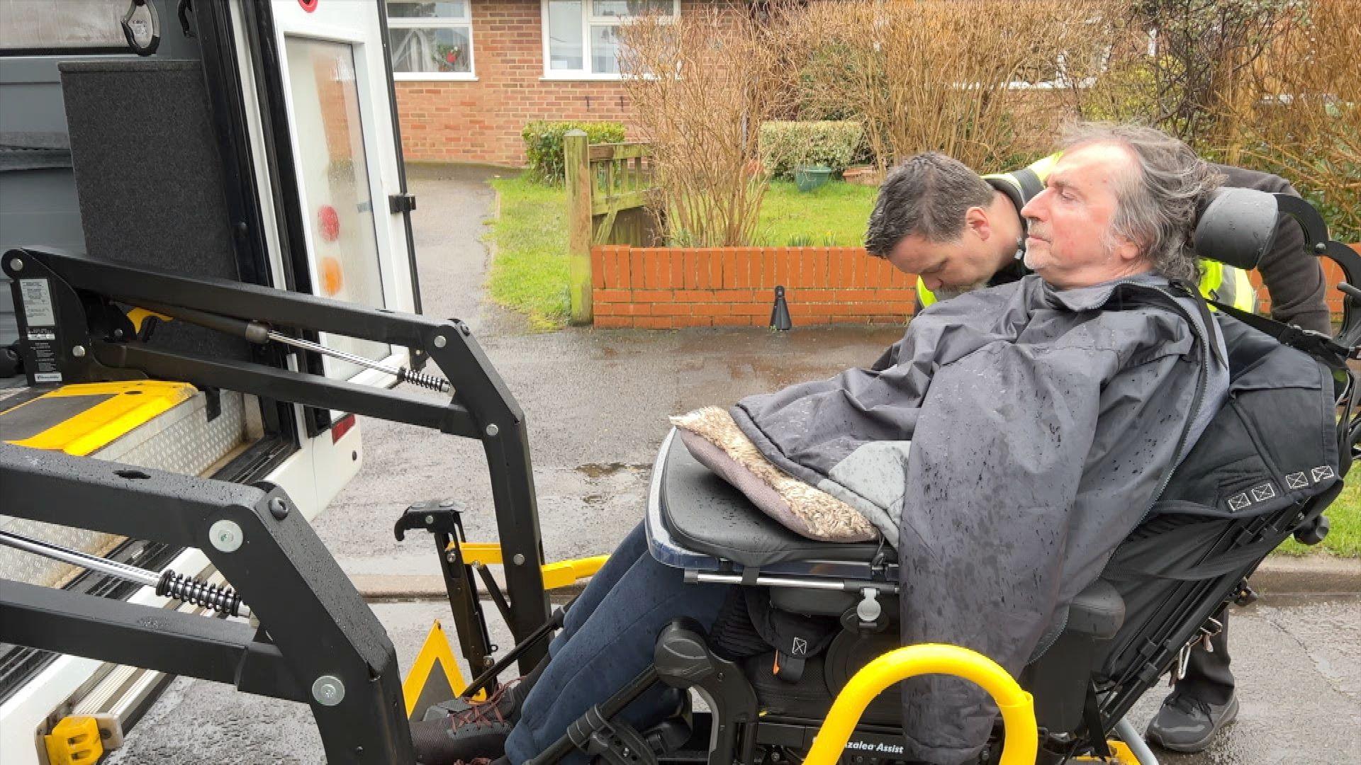 Steve Barnes is lifted into the minibus that takes him to Greenfield House one day a week.