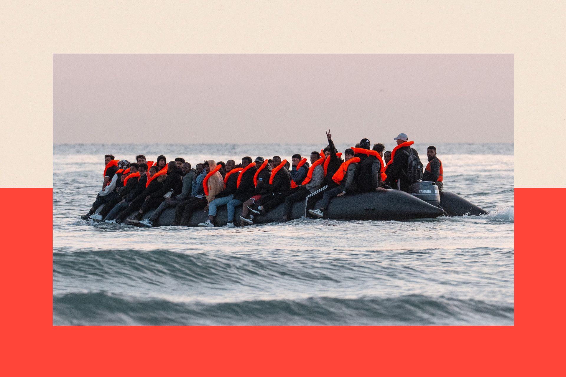 A man gestures from a dinghy as migrants prepare to sail into the English Channel