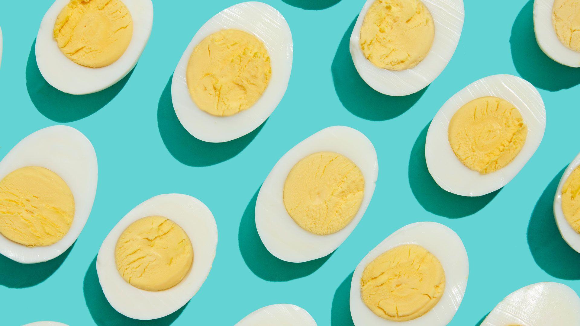 Halved hard-boiled eggs on a light blue background