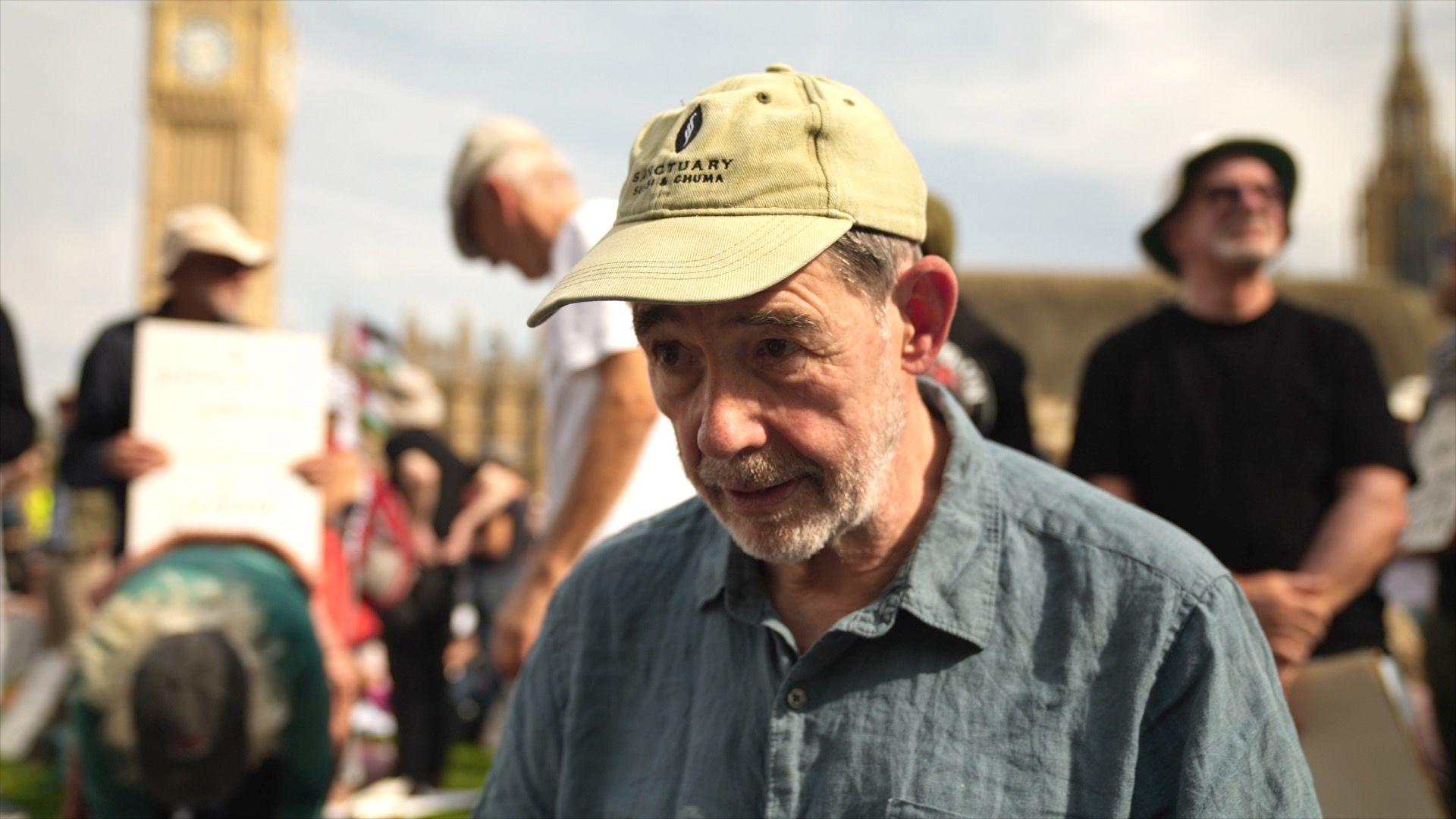 Sir Jonathon Porritt in a beige cap at the protest