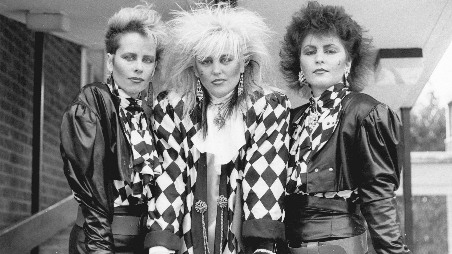 Anita, Penny and Ruth in 1985, in a black and white image, all wearing black and white. 