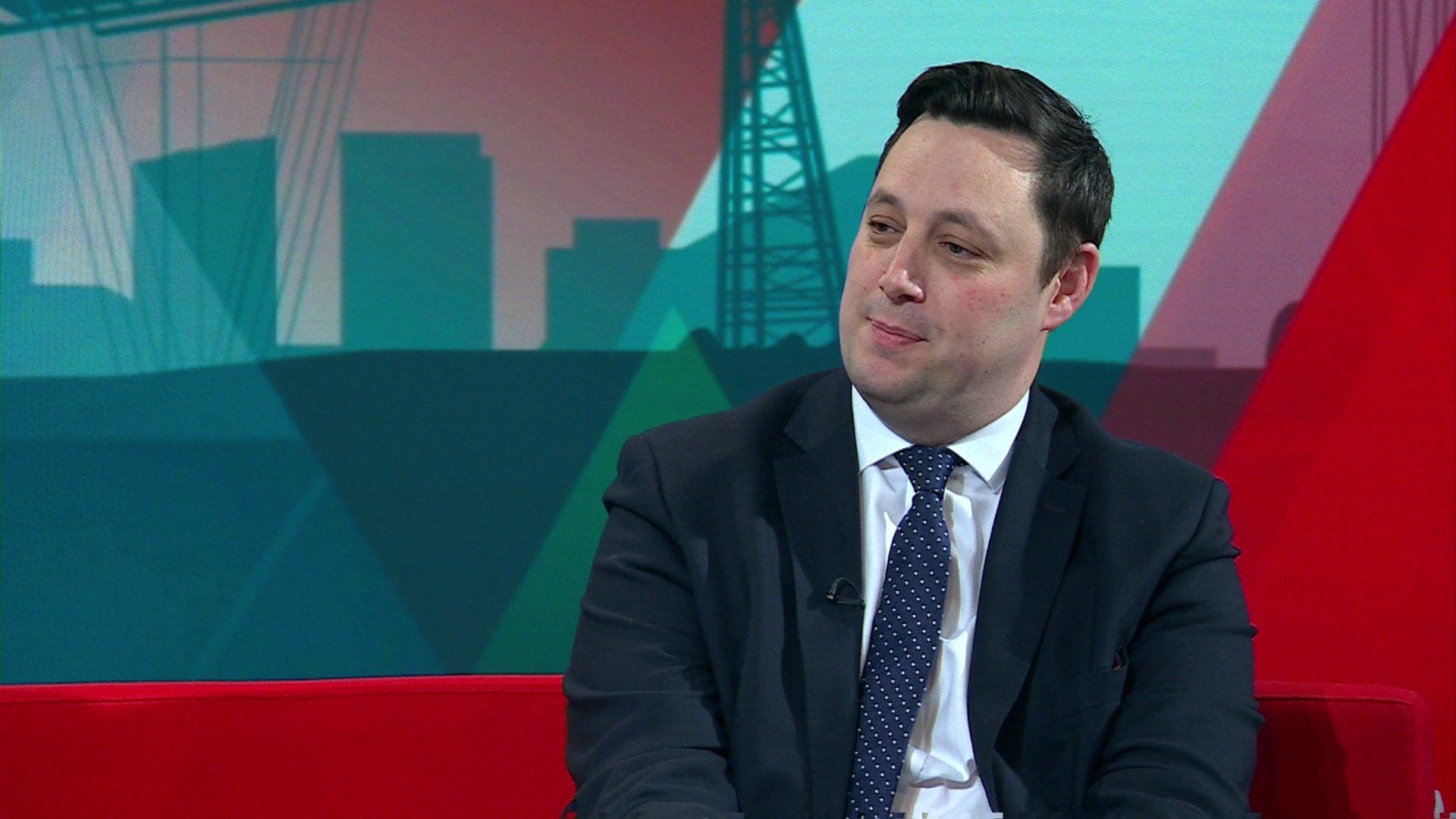 Lord Ben Houchen, wearing a navy tie with white polka dots and a white shirt, sits on BBC Politics North's red sofa.