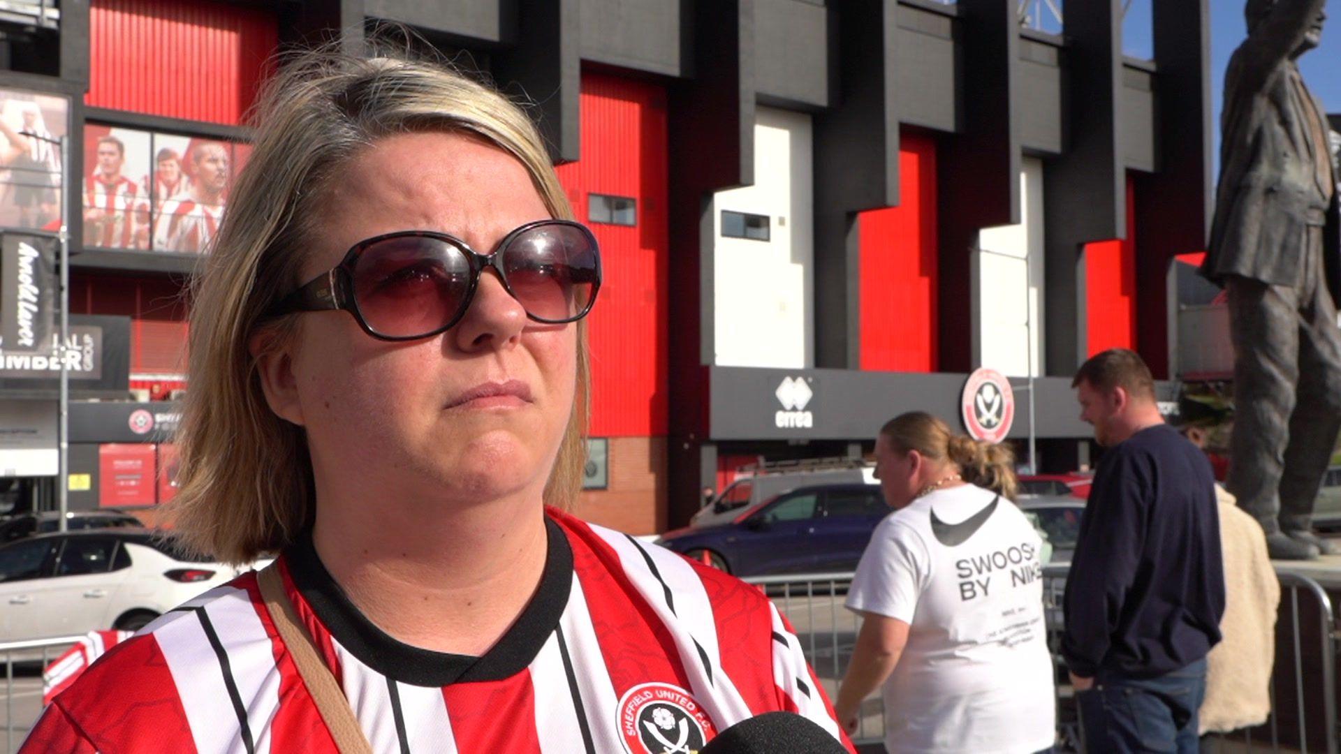 A woman wearing a red and white shirt with sunglasses