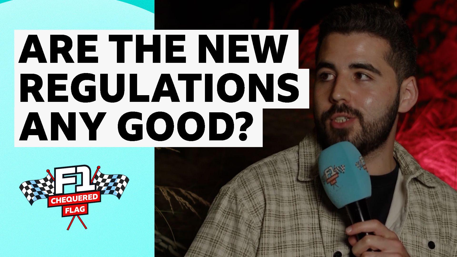 The Chequered Flag Podcast presenter Harry Benjamin holds a microphone in his hand.