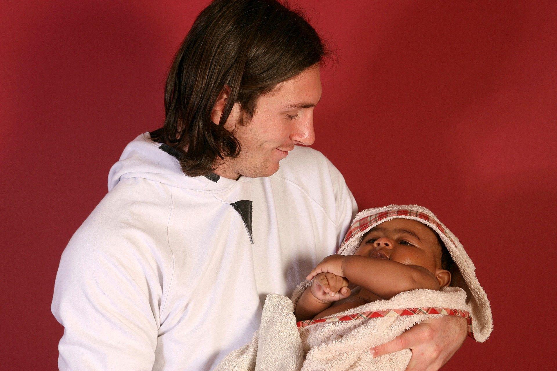 Lionel Messi cradles a baby Lamine Yamal in a bath in the away dressing room at Barcelona's Camp Nou stadium in 2007