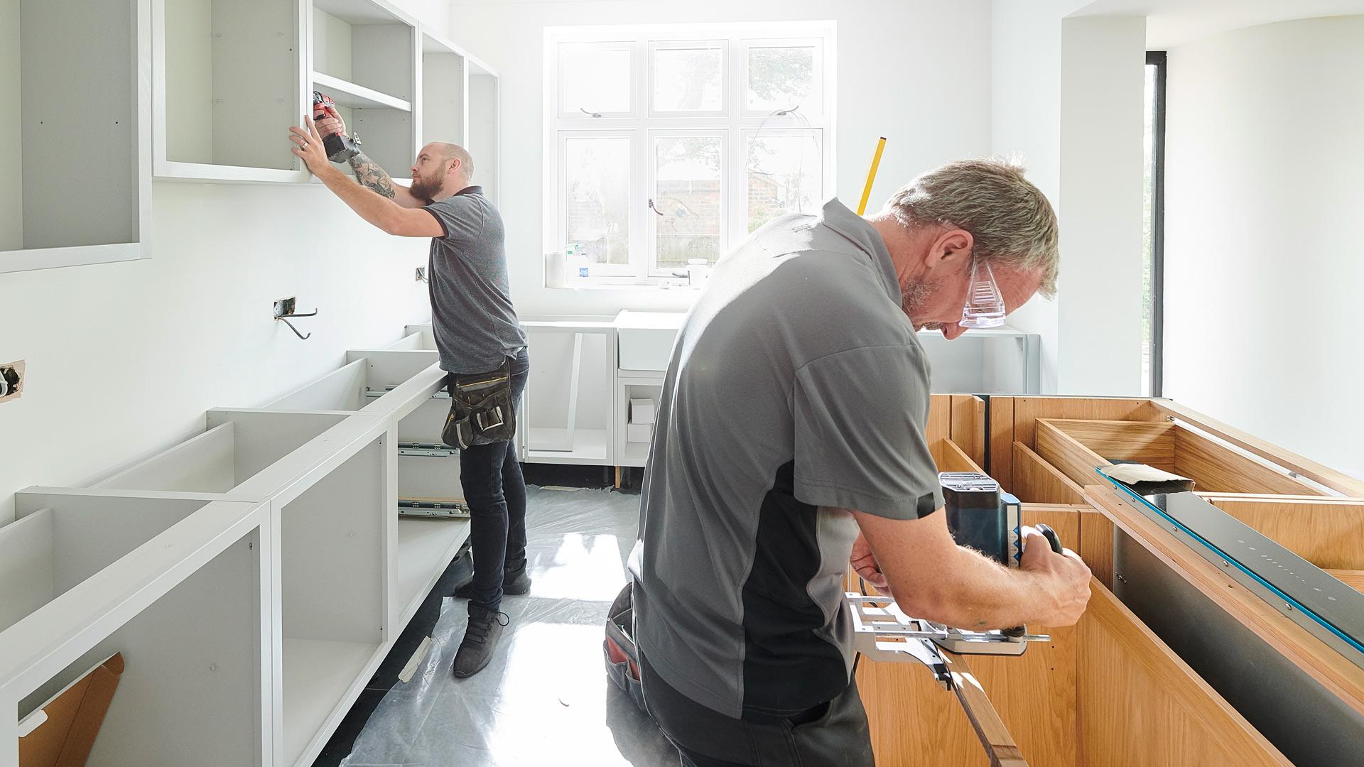 Two men fitting a kitchen