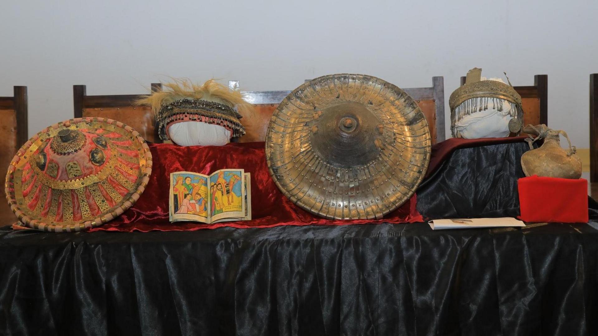 A display of historical crowns and paintings