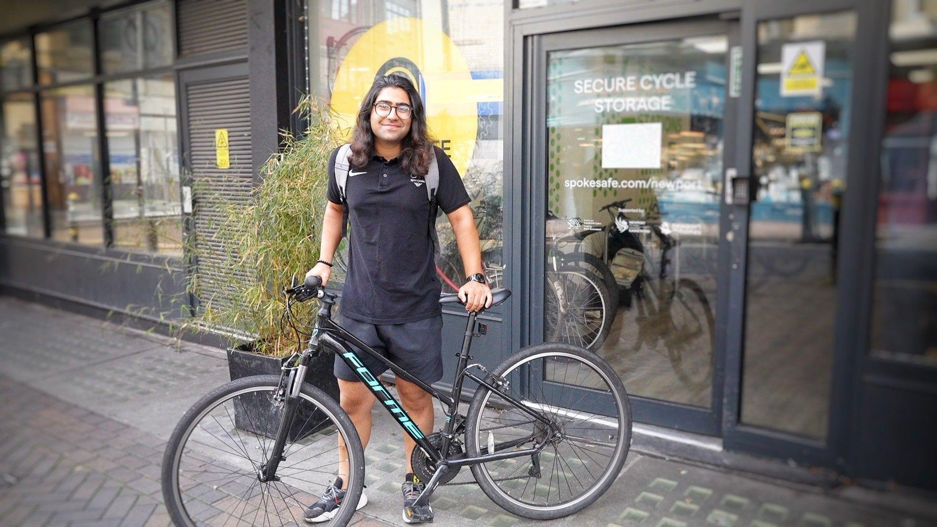 Ben standing with his bike in front of Newport Cycle Hub.