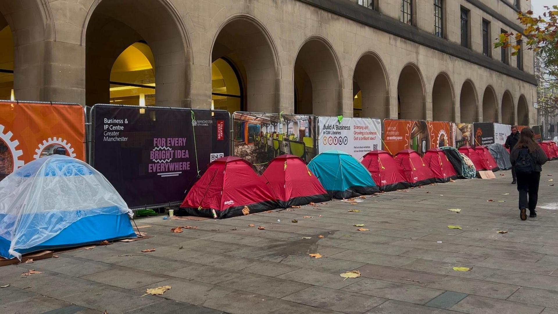 A line of tents of various colours outside Manchester town hall