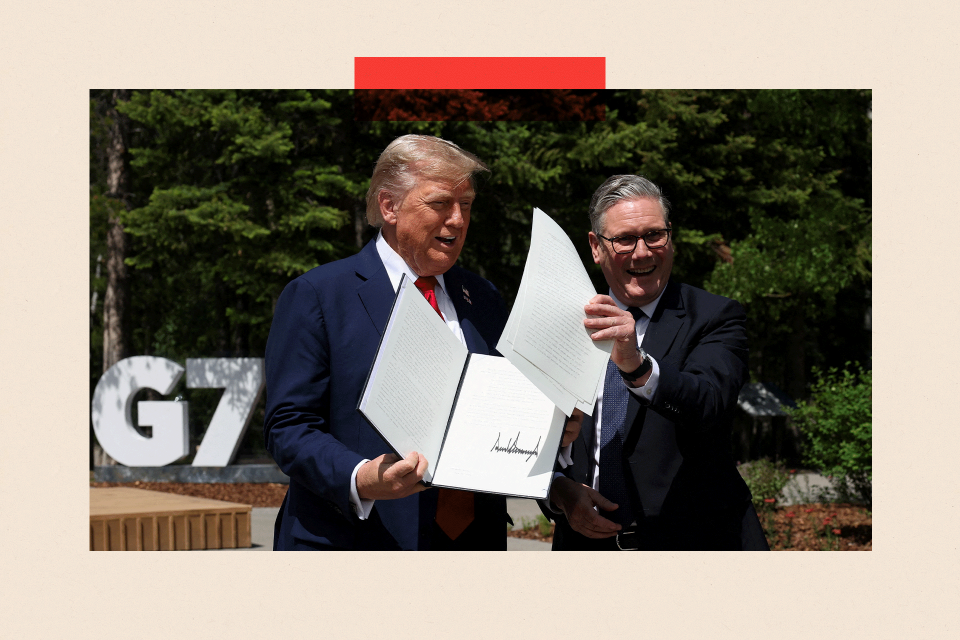 U.S. President Donald Trump and British Prime Minister Keir Starmer hold a signed Trade Agreement during a meeting at the G7 summit
