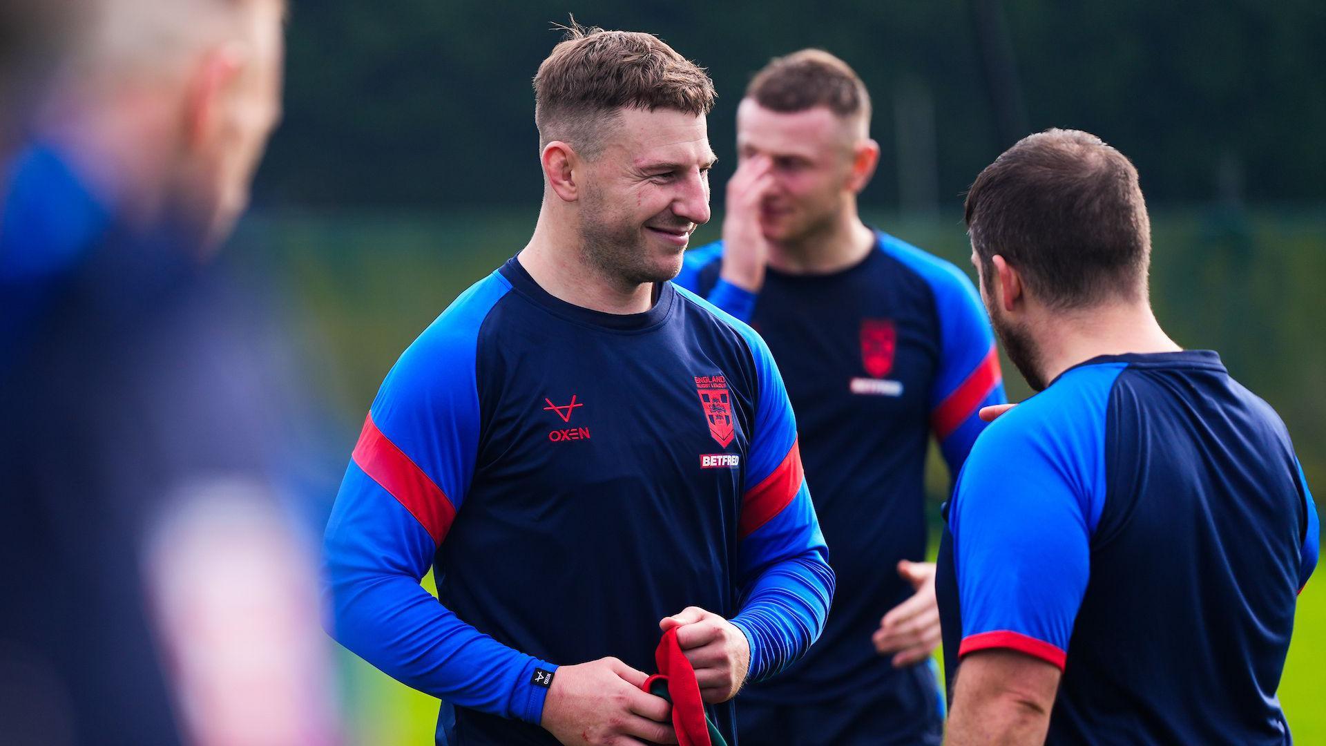 George Williams laughs as he chats to England strength and conditioning coach Chris Baron during a training session