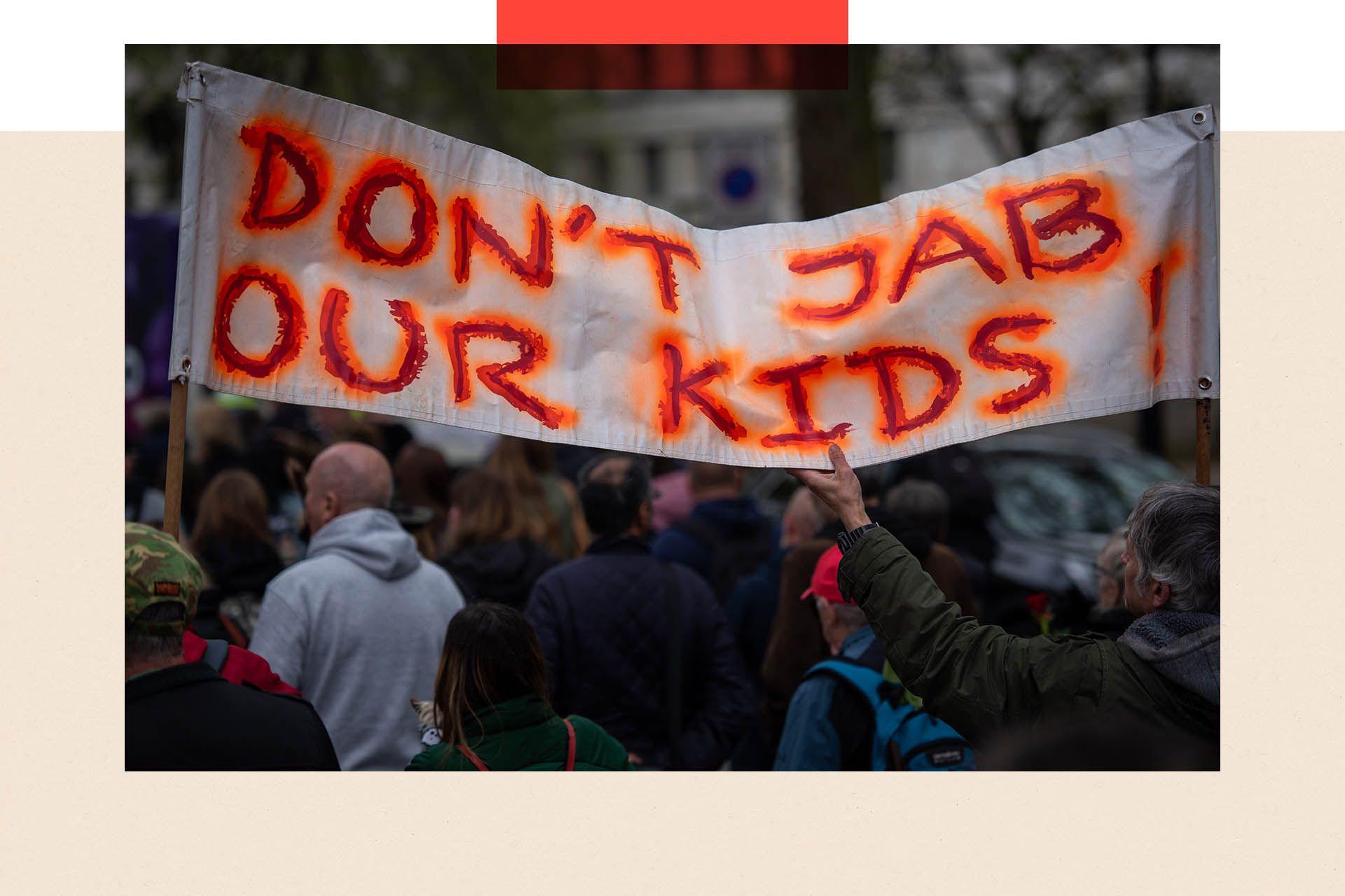 Protesters hold a banner which states: Don't Jab Our Kids