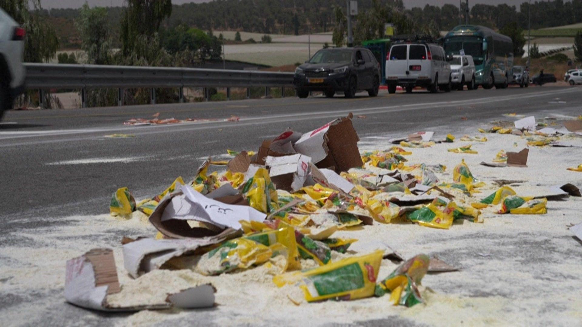 Aid strewn on the road after an attack by Israeli settlers