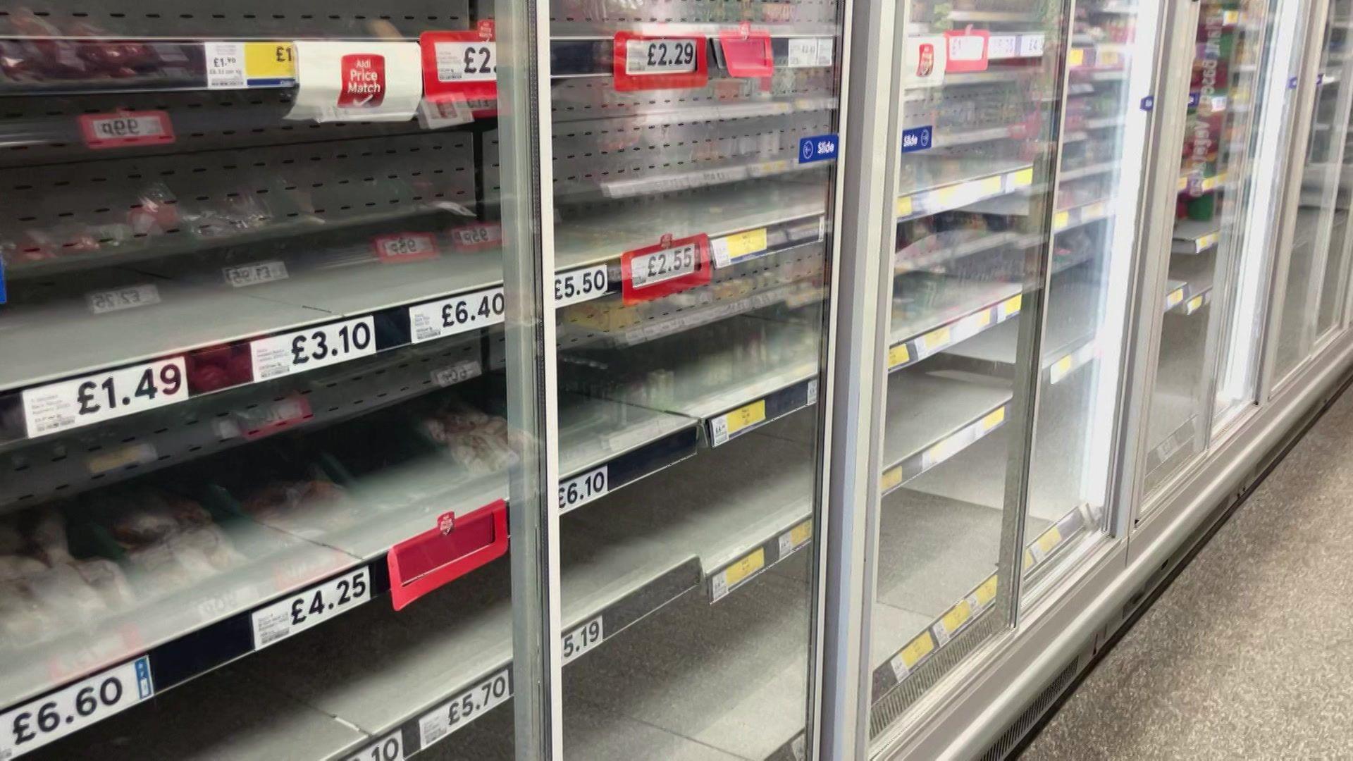 A row of empty fridges in a supermarket