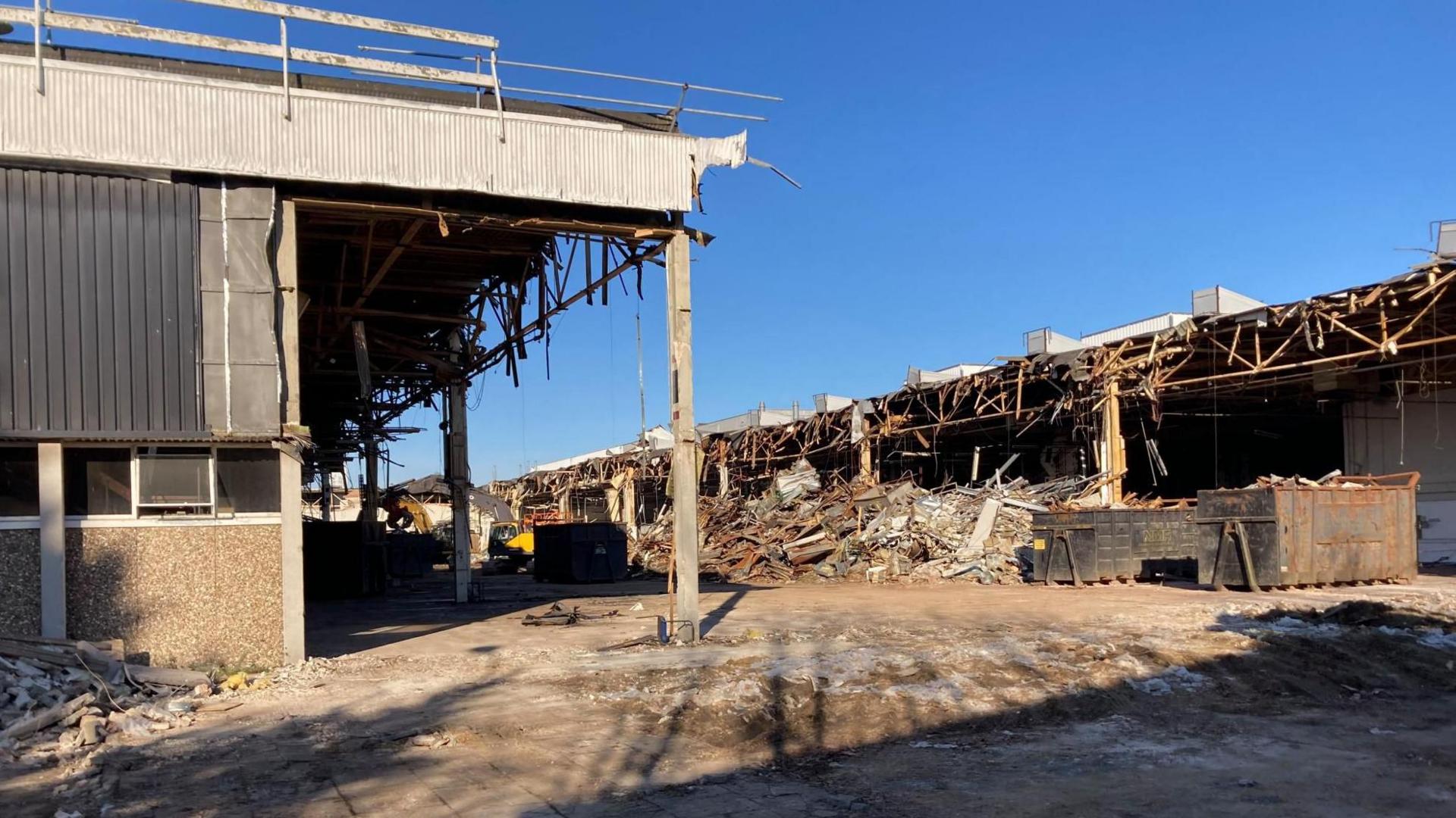 Part of former Delphi factory has been removed, leaving two stand alone buildings, rubble and twisted metal can be seen on the floor.