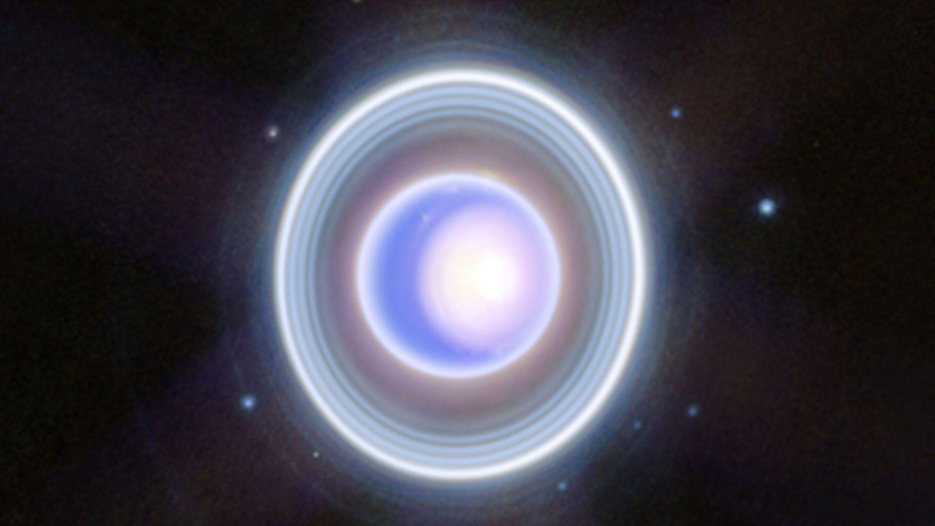 A blurry image of Uranus with dots around the outside