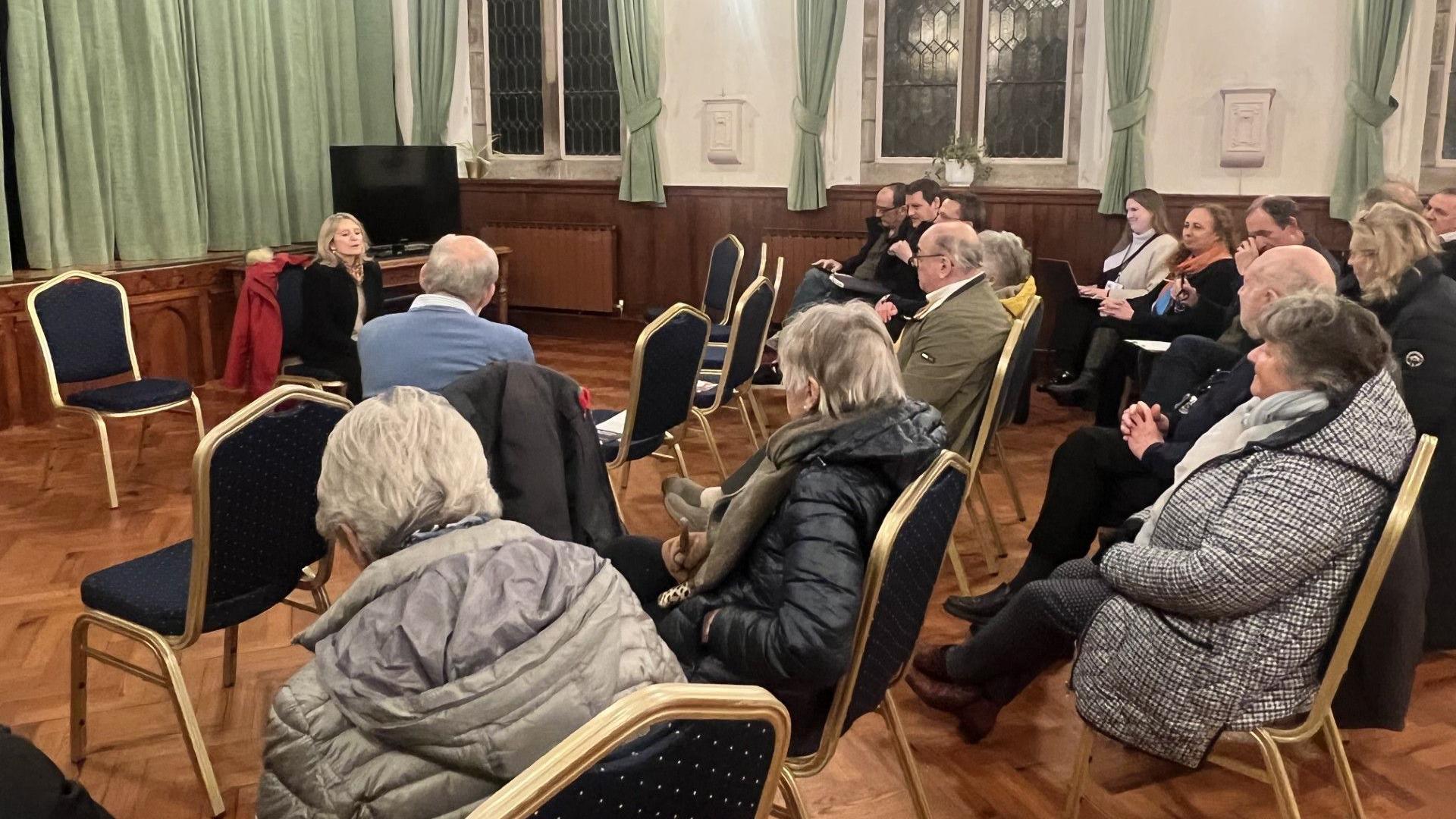 There are more than ten people listening to Elaine Millar in St John parish hall 