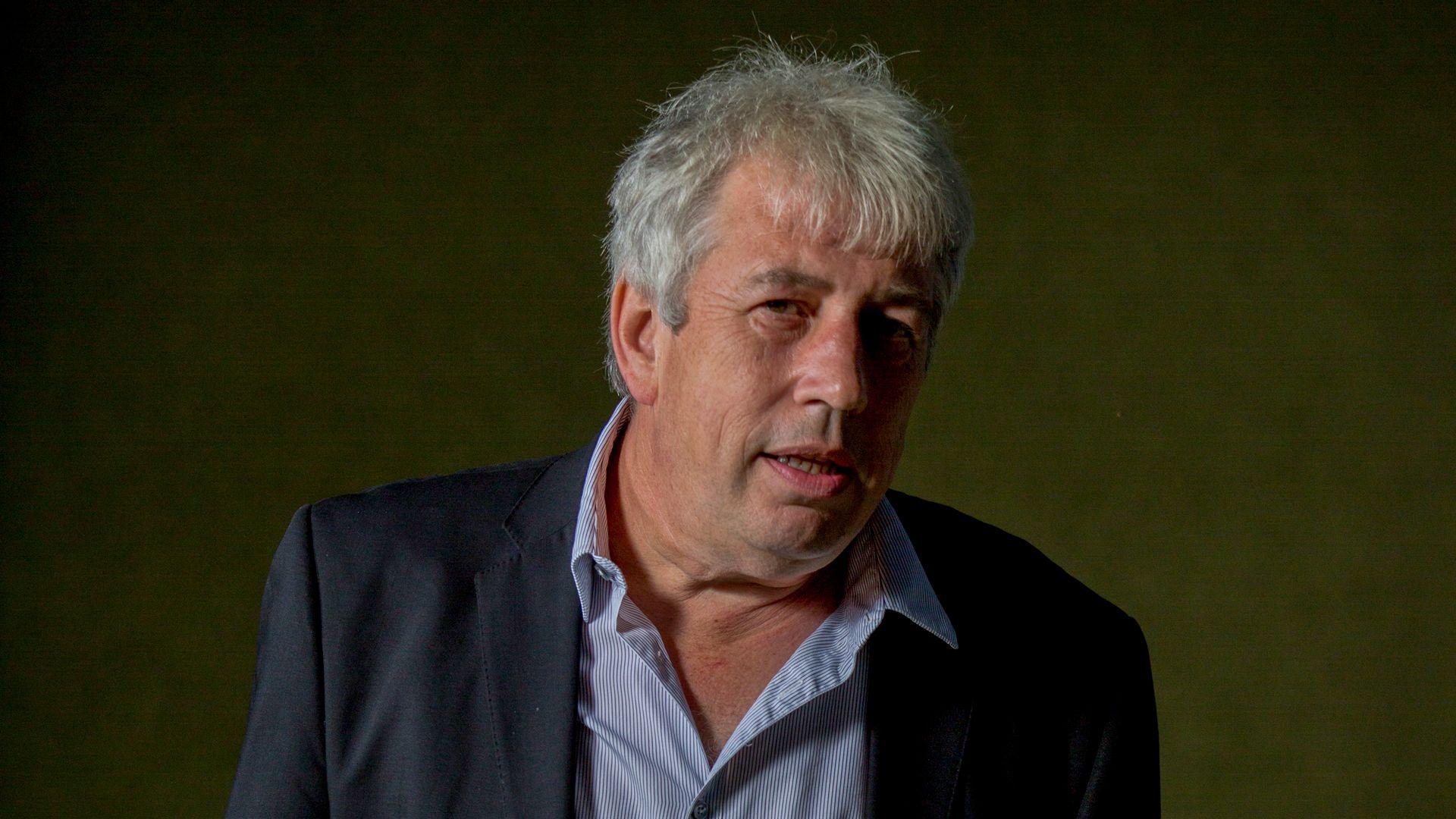 Rod Liddle looking up to his right, wearing a blue-striped shirt and navy jacket