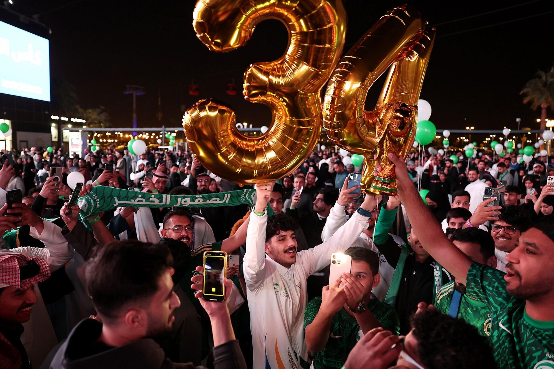 Members of the public celebrate as Saudi Arabia is announced as the host nation for the FIFA World Cup 2034 in Riyadh, Saudi Arabia.