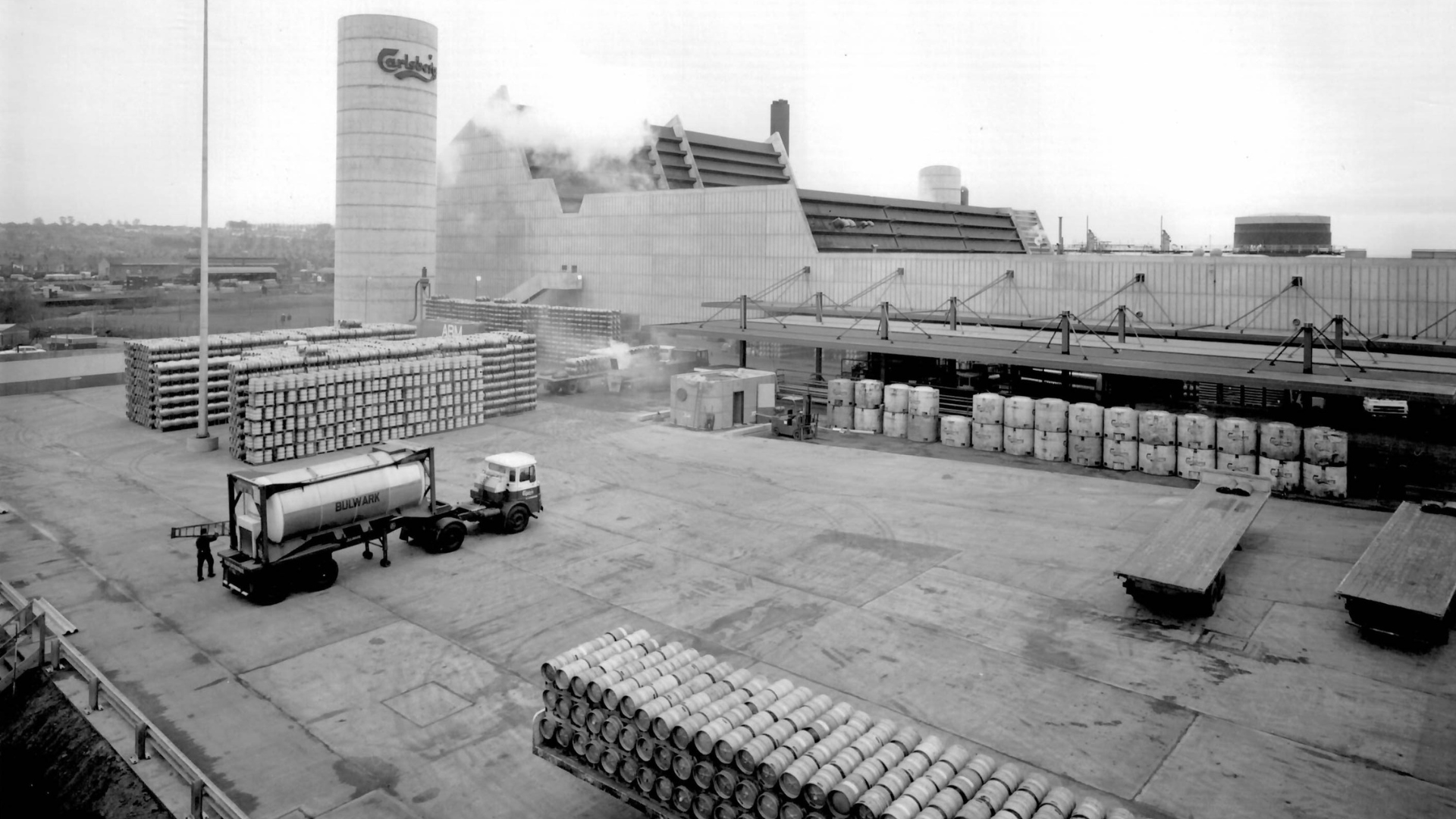 Factory yard, showing pallets of lager and a lorry