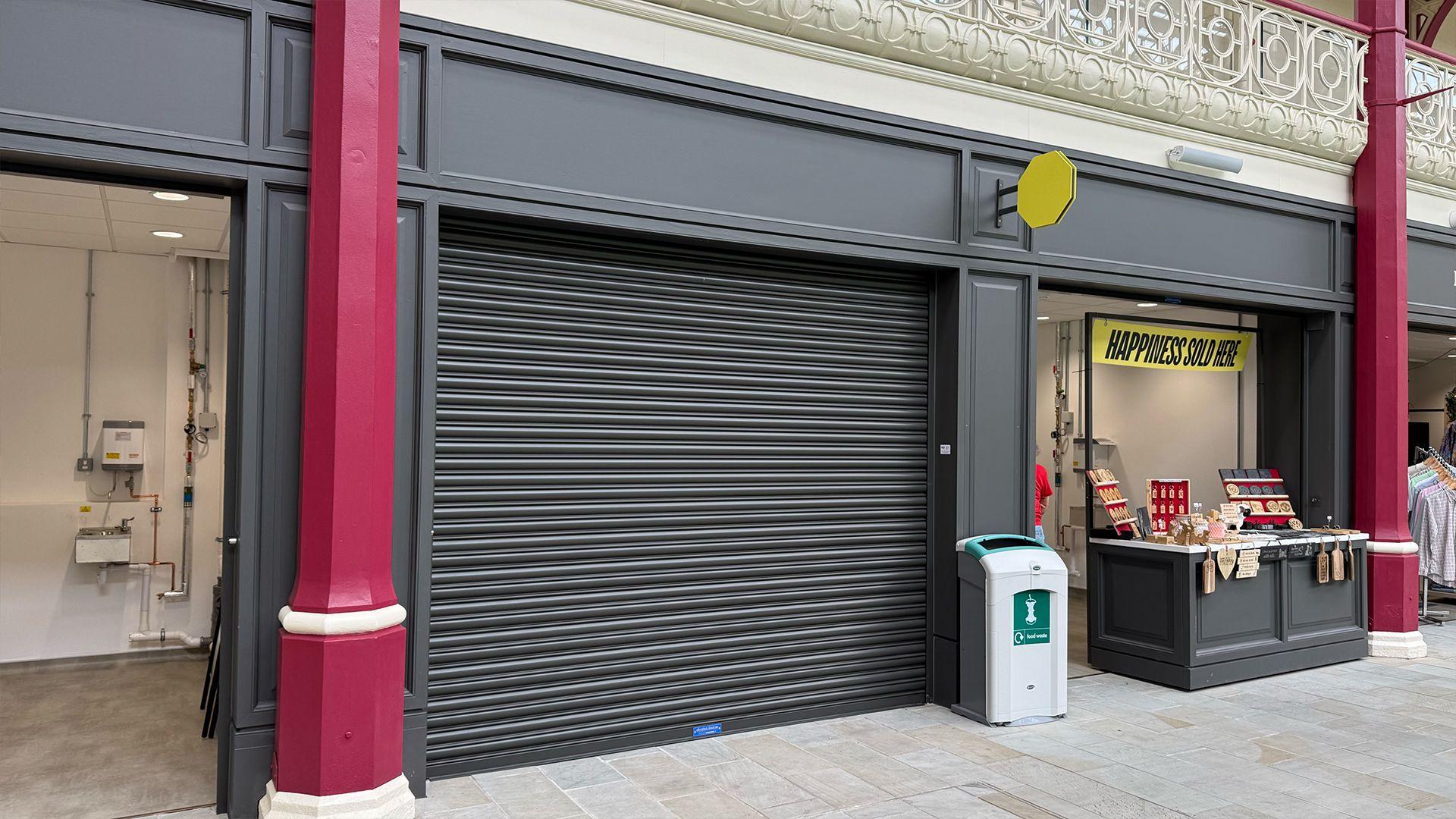 An empty unit with the shutters down inside Derby's new Market Hall
