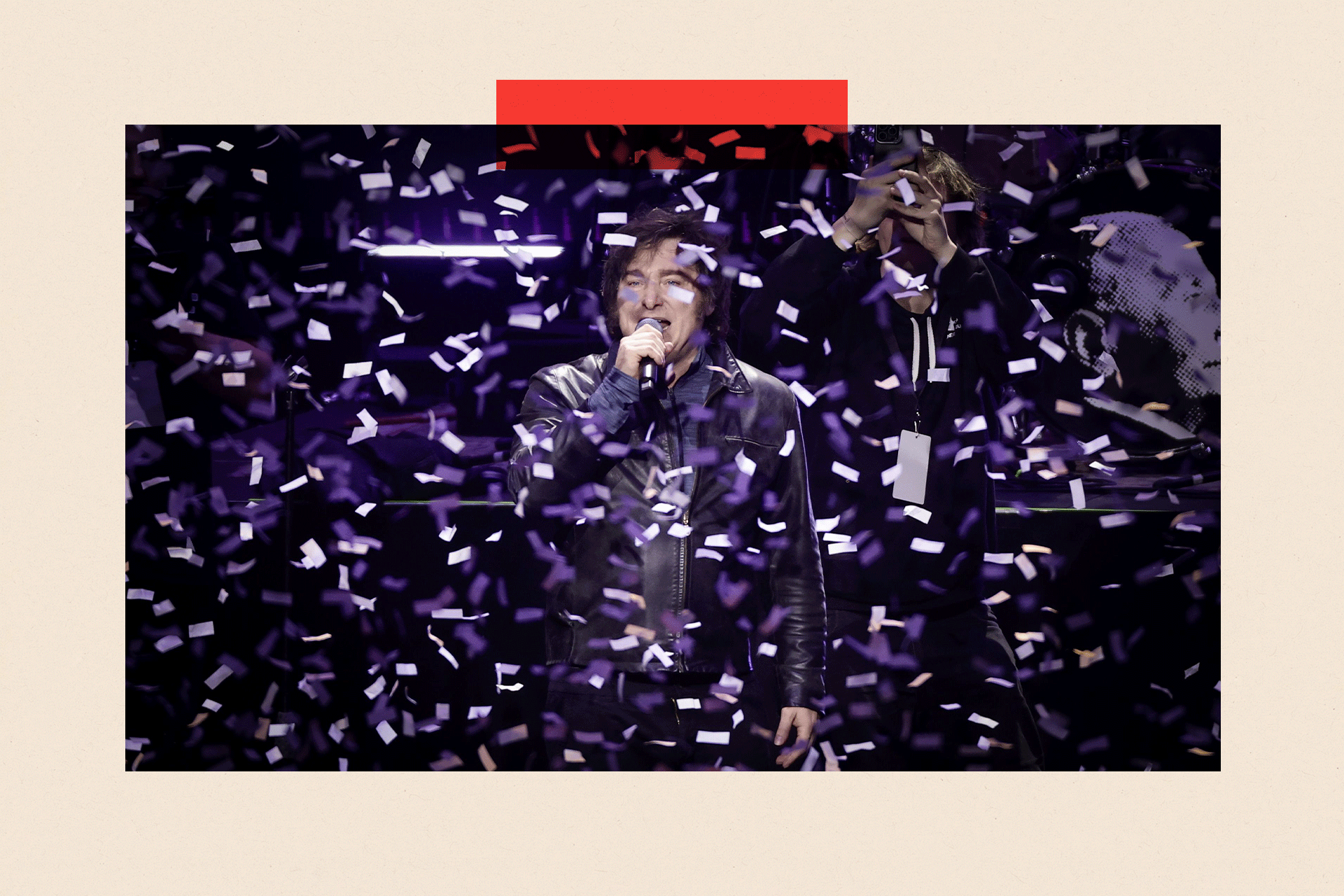 Javier Milei speaks during an event with confetti surrounding him