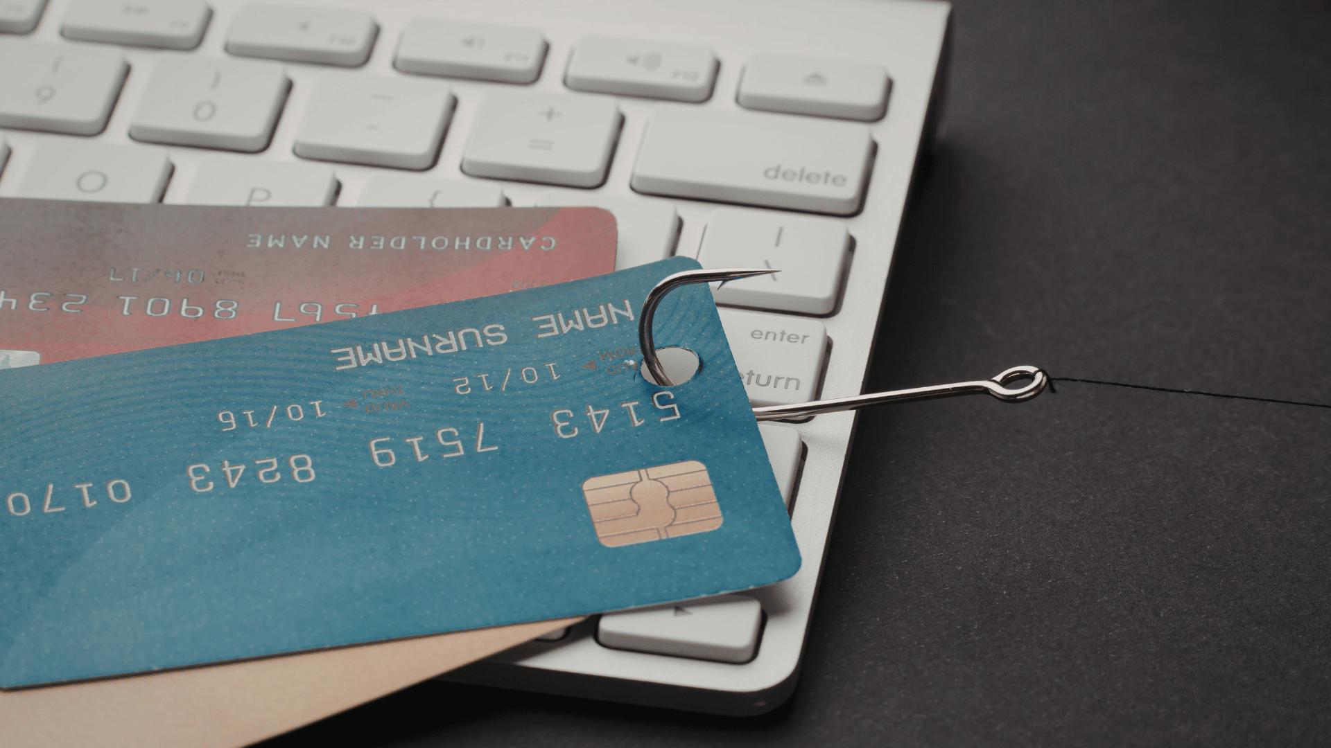 Image shows a credit card being hooked by a scammer