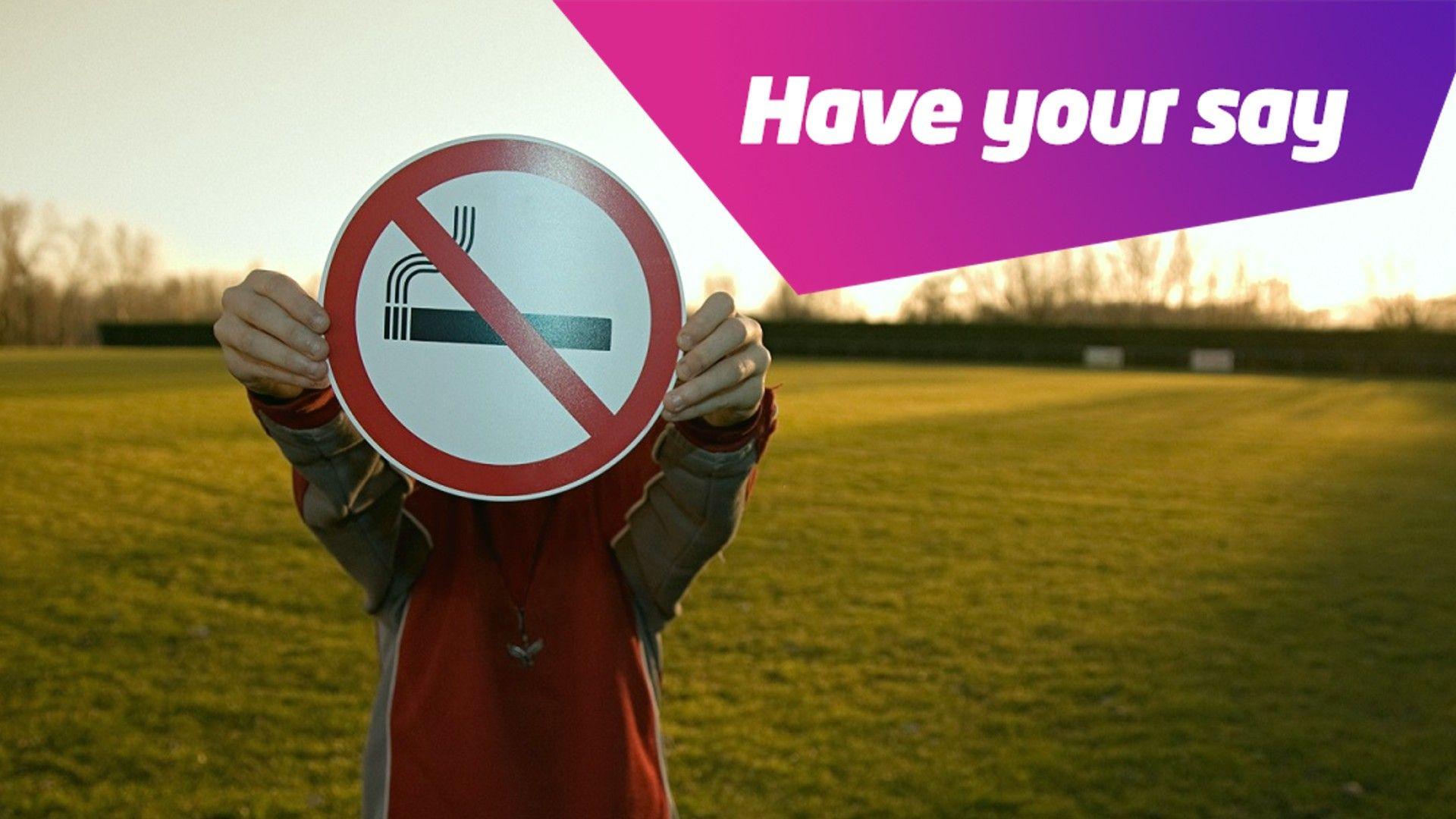 boy holding no smoking sign. 