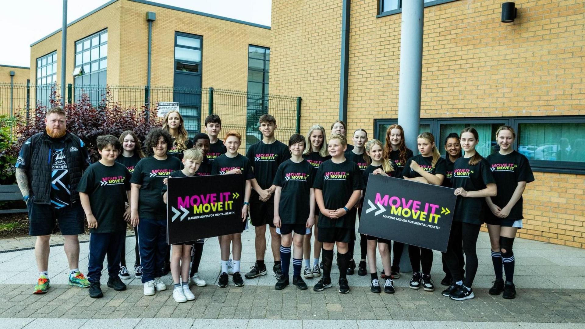 School children holding Move It For Mental Health signs 