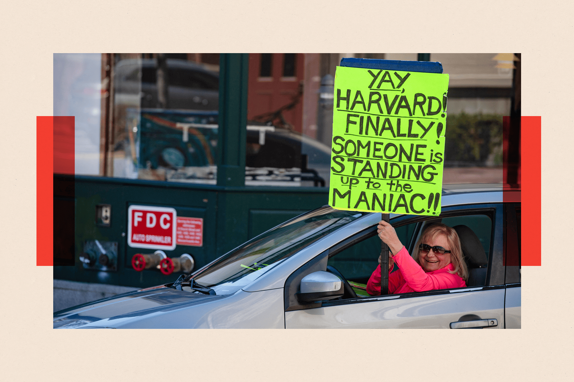 A demonstrator holds a sign in Harvard Square after a rally was held against Donald Trump's attacks on Harvard University on 17 April 2025.