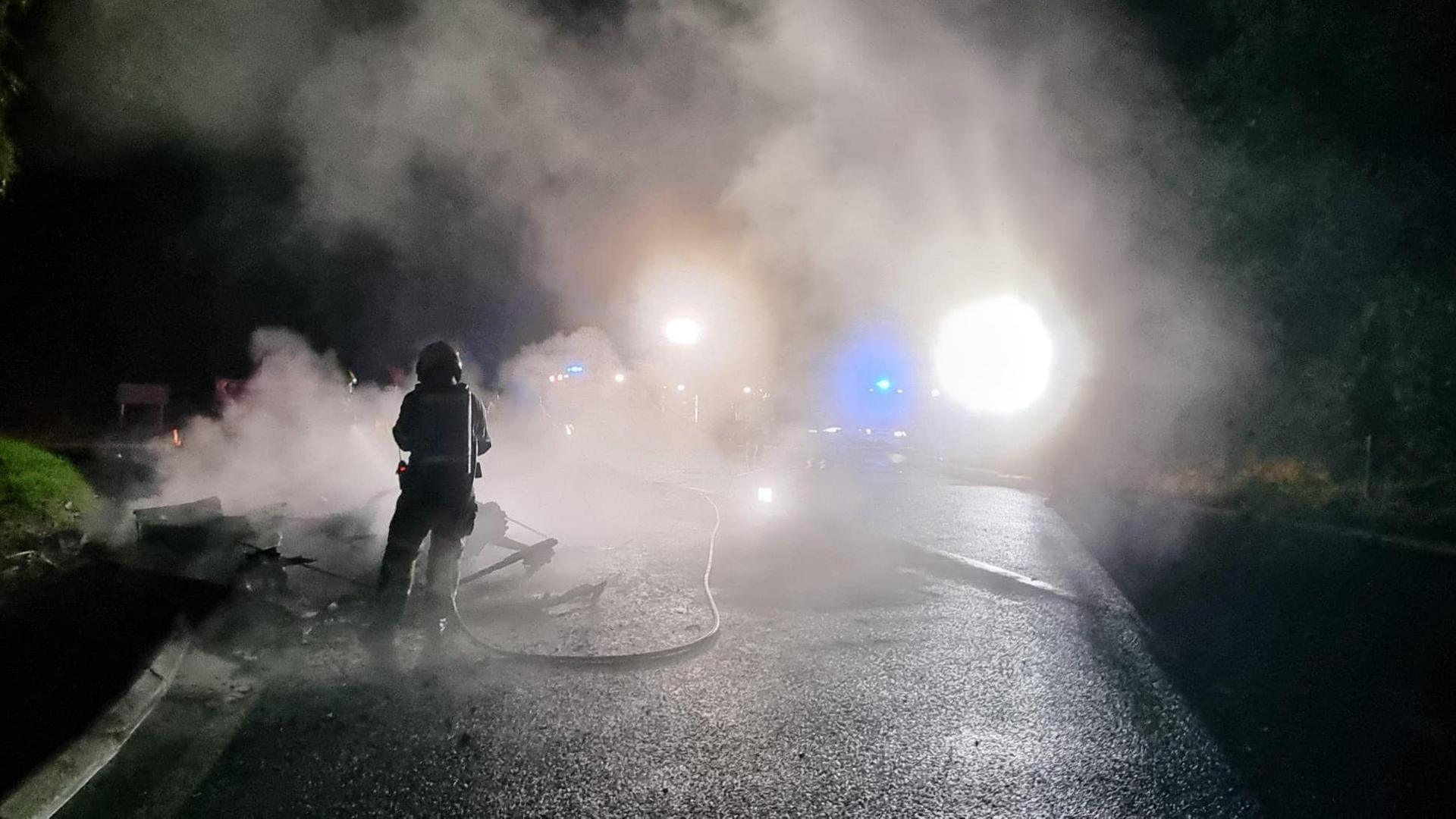 A firefighter tackles the fire on the A5