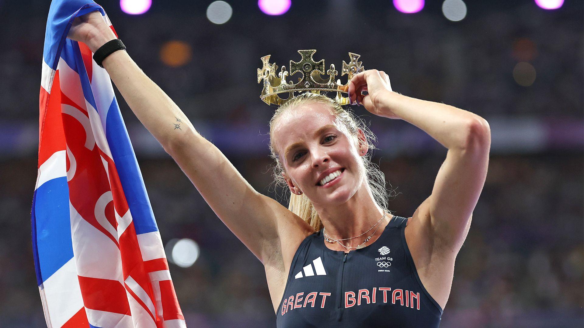 keely hodgekinson holding a great Britain flag and a crown above her head