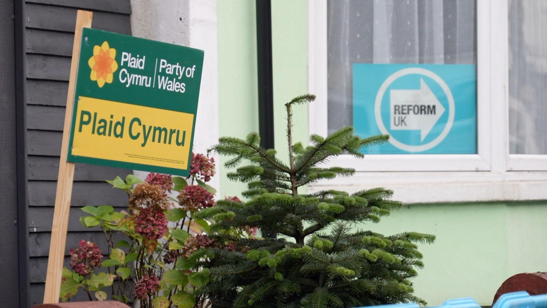 Plaid Cymru and Reform UK signs in the windows of houses in Caerphilly, Wales