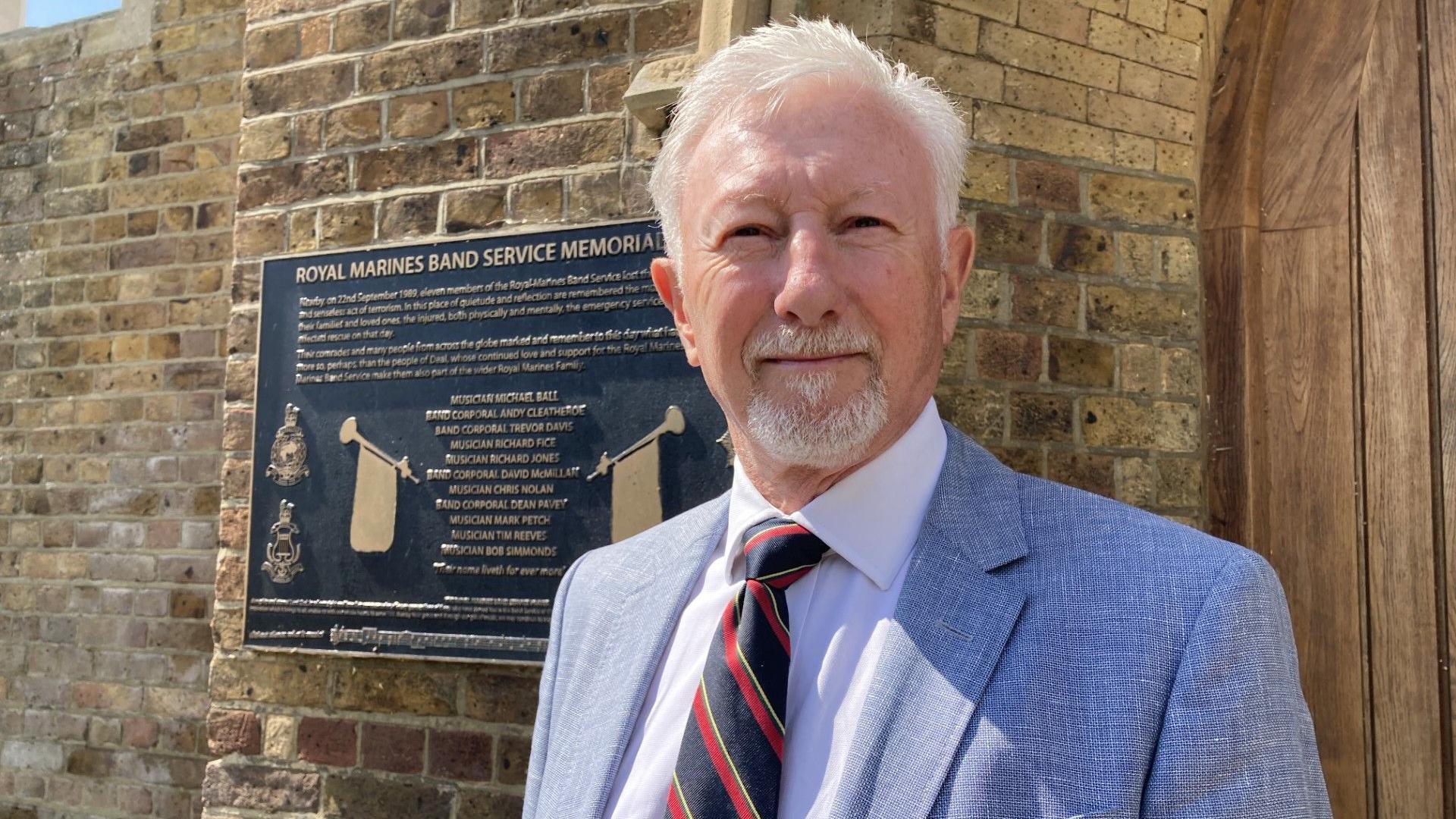 Derek Lindars standing outside the Royal Marines memorial garden in Walmer, Deal