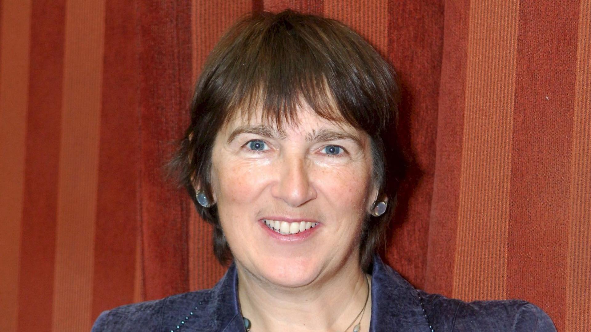 Photo of Helen Daltry smiling and wearing a blue jacket