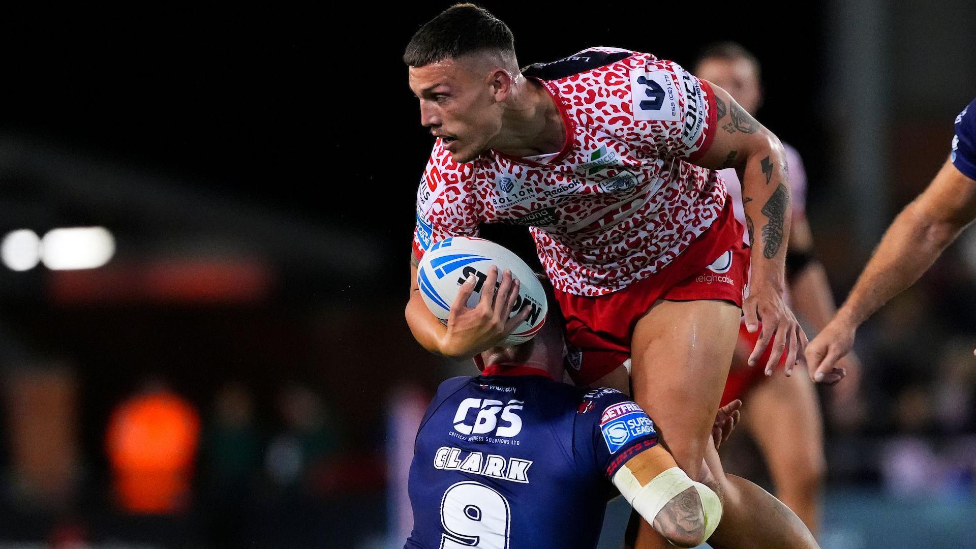 Owen Trout tries to progress but is stopped by Daryl Clark making a low legs tackle as Leigh play St Helens in Super League