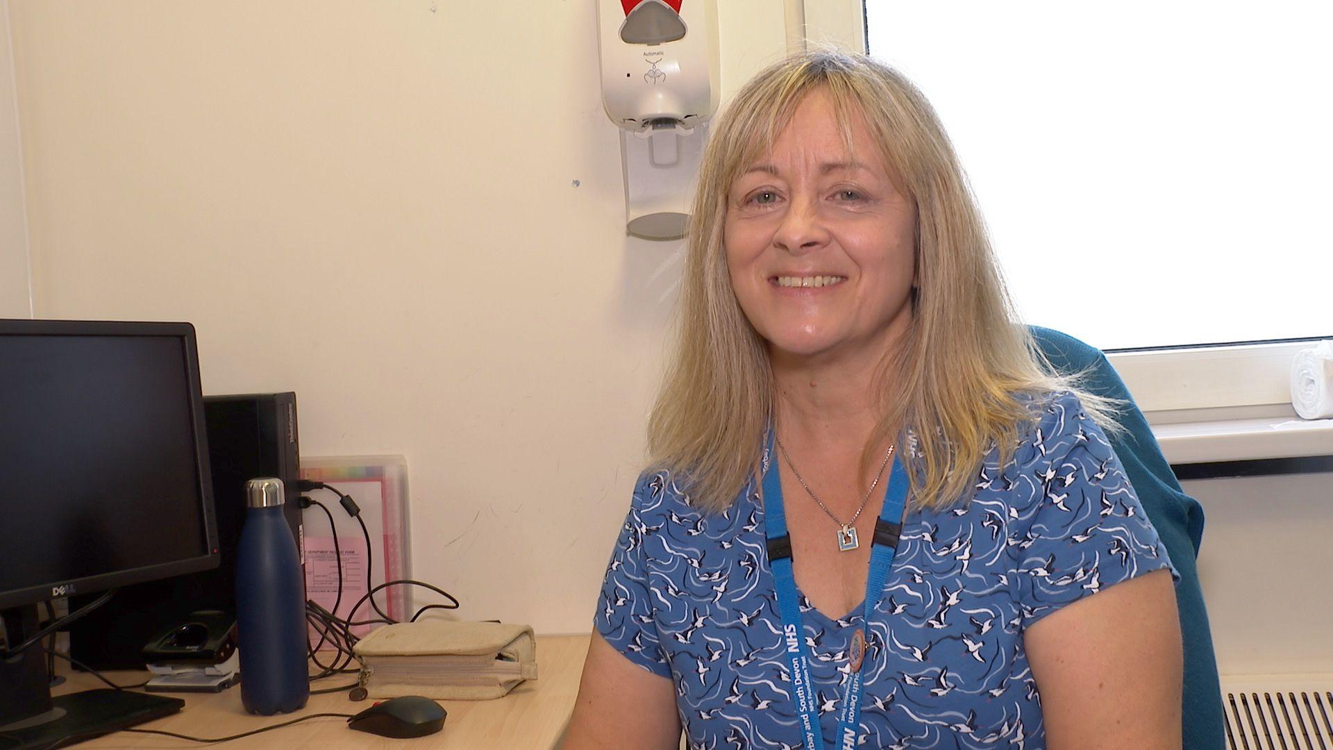 Dr Kathryn Medcalf sitting at a desk