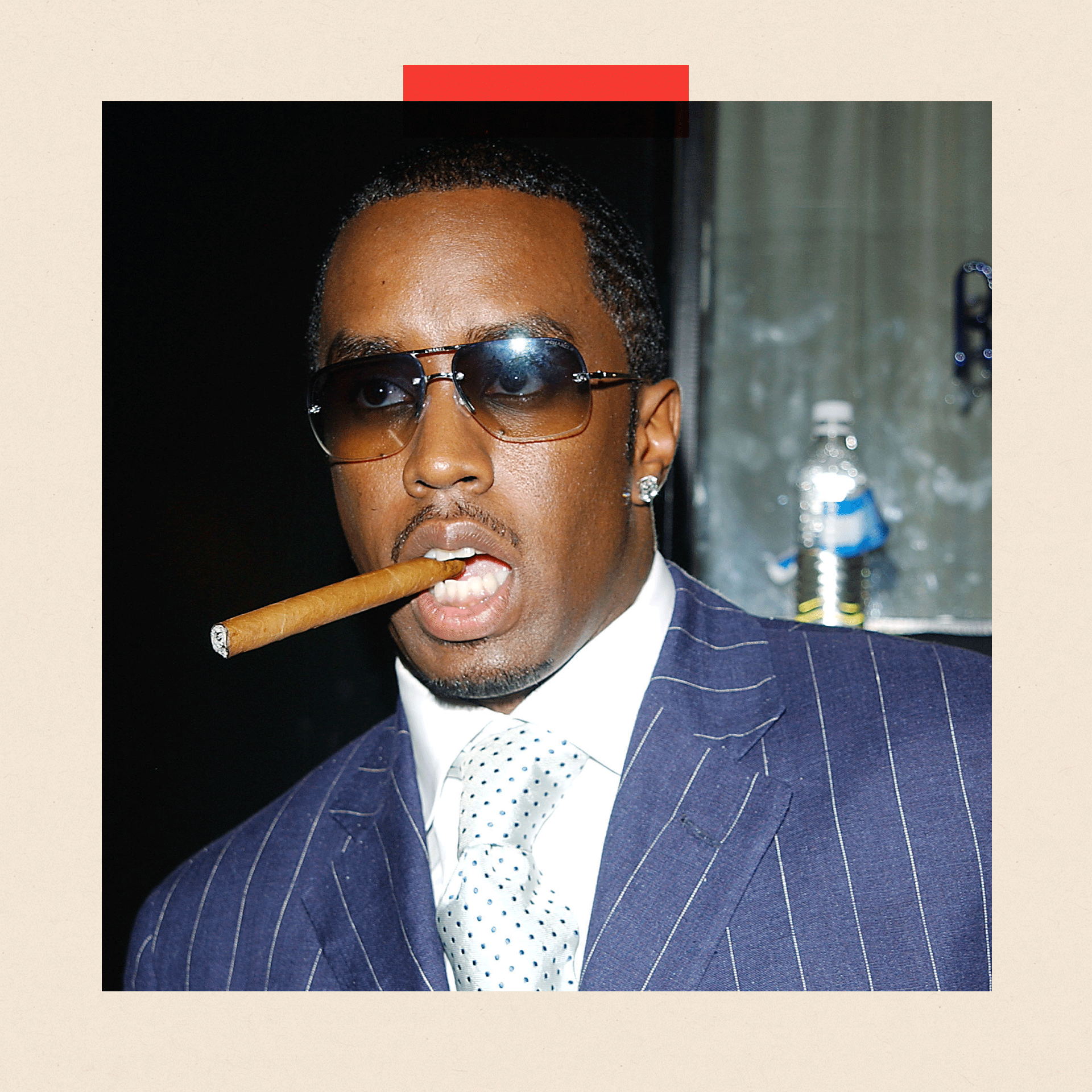 Sean "Diddy" Combs in a suit and sunglasses, with a cigar in his mouth
