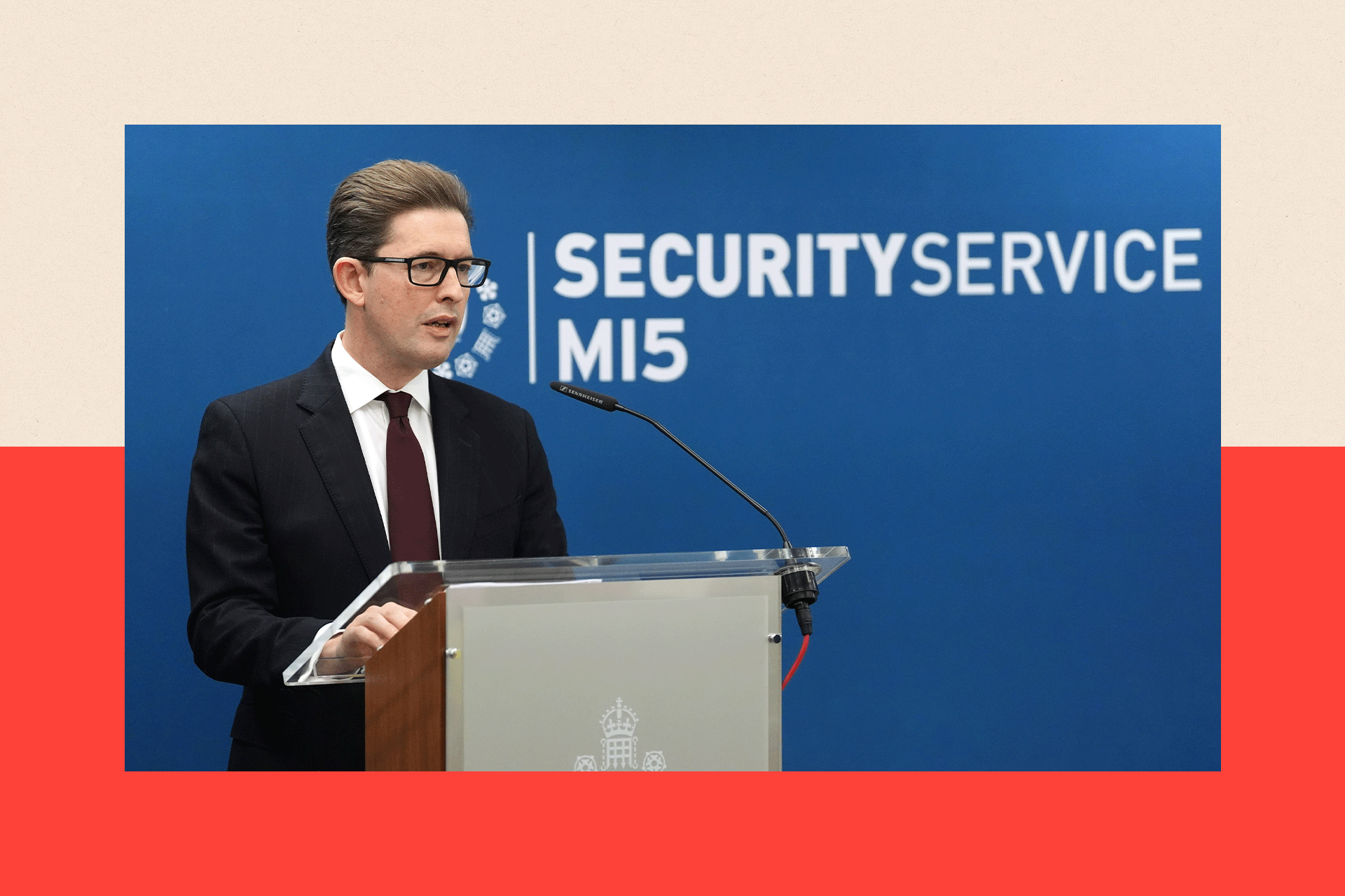 Ken McCallum standing at a podium